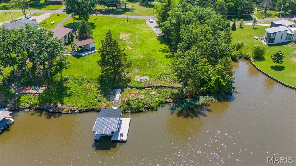 94 feet of waterfront awaits at this exceptional Indian Lake property! Opportunities like this are rare, with very few vacant waterfront lots remaining. This lot is ready for your dream lake home, featuring a new driveway, electricity already on site, and valuable waterfront improvements including new concrete steps leading to the dock. The dock is equipped with a boat lift and a convenient fish cleaning station, making it easy to enjoy everything lake life has to offer from day one. Located within the gated Indian Hills community, Indian Lake offers approximately 326 acres of water recreation including boating, fishing, skiing, tubing, and jet skiing. Residents enjoy access to a sandy swimming beach, playground, tennis and pickleball courts, horseshoe pits, basketball courts, and a community center that hosts events and is available for private rental. A full-service marina adds even more convenience to lake living. Visit www.ilpoa.org for additional community information. Don't miss this opportunity - schedule your private tour today!