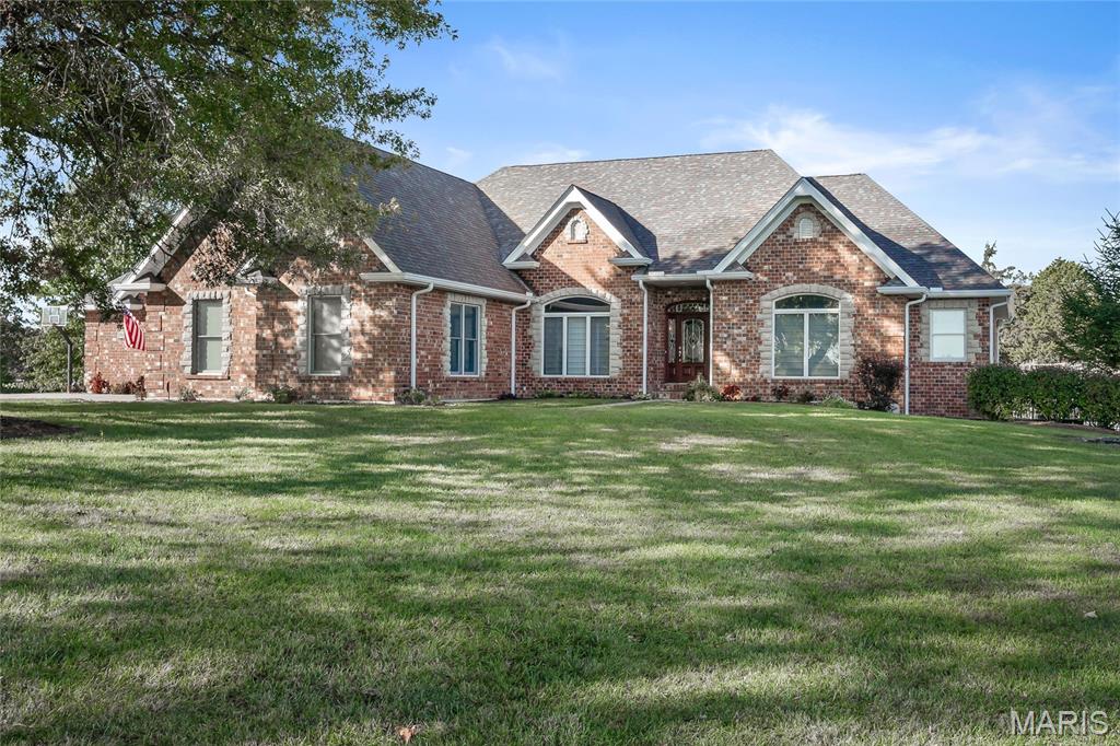 Welcome to your dream country estate! This custom-built full brick masonry ranch offers 4,562 sq ft of luxury living, with 3,100 sq ft on the main level. Nestled on 17 picturesque acres adjoining Reifsnider Conservation Area, this private retreat offers unmatched serenity and potential for a multi-home family compound with multiple building sites. Enjoy summer days by the inground pool and surrounding patios. A welcoming foyer is flanked by French doors leading to a quiet home office and a separate dining room perfect for gatherings. The split floor plan includes 4 spacious bedrooms, one with a private entrance, full bath, and dedicated HVAC—perfect for a guest suite. The master ensuite offers a coffered ceiling, large jacuzzi tub, custom tile work, glass block dividers, and doors leading to your private deck for morning coffee. The chef’s kitchen is a showstopper with 9-ft tall blonde hickory cabinetry, quartz counters, a huge island with prep sink, professional gas cooktop, Sub-Zero fridge, wine cooler, coffee bar, and wall ovens. The vaulted great room boasts a floor-to-ceiling stacked stone fireplace. Discover a finished lower level with decked out wet bar and multiple entertaining spaces, fireproof vault, exercise room or an additional sleeping room, and abundant storage! Insulated and drywalled 4-car oversized garage with additional storage. You will never run out of hot water with solar-heated water and reverse osmosis system. Acreage provides for a large lake site.