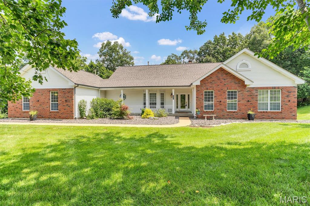 Nestled in the highly sought after Radcliffe Place subdivision... This beautiful 3 bedroom ranch home features a custom 18 x 18 Patriot Four Season room with a swim spa!  This Oasis sits on a 1.2 acre lot that features a newer composite tiered deck overlooking the serene woods.  Enjoy the fabulous walk-in (year round) swim spa which features 25 jets located off the Primary Suite with a separate entrance from the peaceful back yard.  Through the gracious entry foyer, step into the Great Room which boasts beautiful hardwood floors and a soaring fireplace with a wall of windows facing Nature.  The over sized 3 car garage has an EV outlet (wall box excluded). Main floor laundry room off garage.  MANY fabulous updates already complete include:  New architectural shingle roof in 2025. New zoned HVAC in 2023. Water heater in 2019. The kitchen features 2 double pantries, double stainless steel oven (23),refrigerator (21) ceramic tile floor, planning desk and breakfast room leading to newer composite desk in 2021.  The spacious primary suite features a large walk-in closet and sliding doors leading to newer swim spa and gorgeous Four Season Room. All bedrooms are generously sized with streaming natural lights. Choice Home warranty policy is in place until 7/2028. Rough-in plumbing already in lower level. This private retreat has been lovingly owned and updated.  Radcliffe Place subdivision has a wonderful pool, tennis and pickleball courts.  Exceptional home in beautiful Wildwood and top-rated Rockwood school district!
