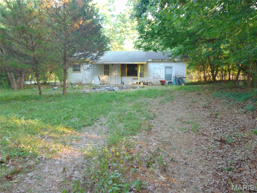 Two bed, one bath home on 5 acres (m/l) just minutes north of Doniphan. Older home in rough condition but probably savable. Owned by a local real estate agent who bought it and has started cleaning it up. Would prefer to sell in its current condition. If it doesn't sell quickly, work will begin to remodel and fix up the home and price will increase accordingly. There is a small triangular lot between the home and the country road which increases privacy. There is a recorded easement to the property. 5 acre (m/l) wooded lot is narrow and deep. Fantastic spot to build a new home or put a mobile home back in the woods.