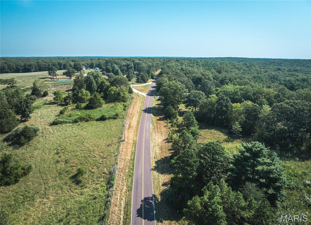 Located just outside of Salem in the heart of Dent County, this 9.3 +/- acre tract offers a rare combination of natural beauty, practical infrastructure, and unbeatable location. With direct frontage along Highway E, access is easy and convenient, making it the perfect spot for a full-time residence, weekend getaway, or recreational basecamp. The land is predominantly level with multiple build sites tucked among mature hardwood timber, offering privacy and flexibility for your dream build. Utilities are already in place with power and a well on site, and a pole barn provides excellent storage for equipment, tools, or outdoor gear. A small pond adds to the property’s charm and provides water for wildlife. Outdoor enthusiasts will appreciate the proximityjust 3.5 miles from Montauk State Park and a short drive to the Ozark National Scenic Riverways, both offering world-class fishing, hiking, floating, and camping. Whether you’re looking to build, recreate, or invest, this property offers the perfect blend of location, amenities, and natural beauty in one of Missouri’s most scenic regions.