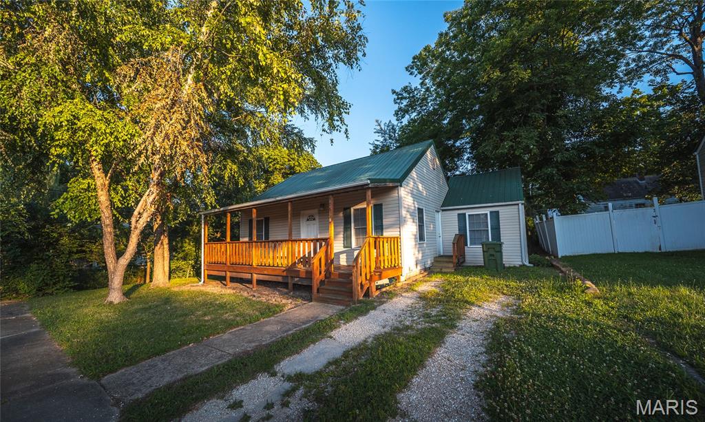 Welcome home to this charming 3-bedroom, 2-bath property ideally located in the heart of Rolla, where convenience meets comfort. Whether you're a first-time homebuyer, looking to downsize, or searching for a place with room to grow, this home offers a wonderful opportunity in an established neighborhood close to shopping, dining, schools, and everyday amenities. Step inside to a bright and inviting interior featuring durable laminate flooring that complements the home's warm, welcoming feel. The functional layout provides comfortable living spaces designed for both relaxing and entertaining, while the HVAC system—just 3 years old—offers added peace of mind for years to come. Enjoy your morning coffee or unwind in the evening on the covered front porch, then head out back to a spacious, level yard where mature trees provide shade and privacy. It's the perfect setting for backyard barbecues, gardening, pets, or simply enjoying the outdoors. The full unfinished basement offers possibilities for extra storage or workshop space. You'll also appreciate the convenience of laundry hookups on both the main level and in the basement, giving you flexibility to customize the home to your lifestyle. With its desirable location, practical updates, and room to make it your own, this Rolla home is ready for its next chapter. Schedule your private showing today and see everything this wonderful property has to offer!