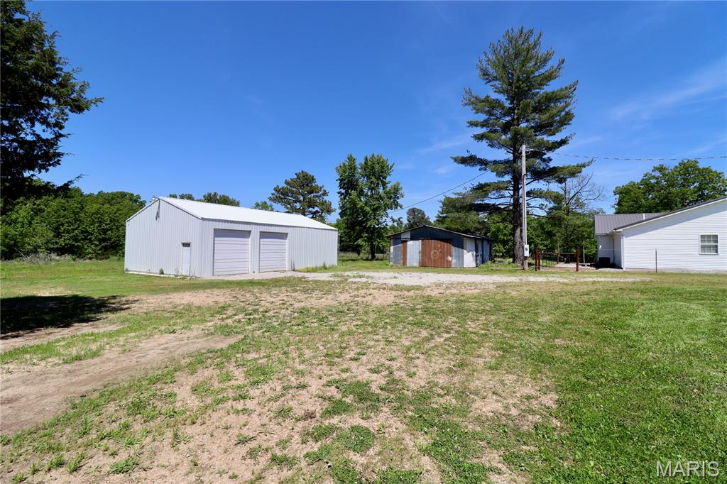 Beautiful 9.69 acre property offering the perfect blend of open space and privacy with partially cleared land ready for your vision. Improvements include a spacious 30x50 shop building and a 24x36 pole barn, providing ample room for equipment, storage, hobbies, or livestock. Property features two electric meters and a public water meter. Whether you’re looking to build your dream home, create a mini farm, or enjoy country living with room to spread out, this property offers endless potential.