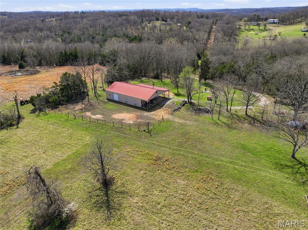 PRICE IMPROVEMENT:BRING OFFERS:  in the Ozarks in the heart of Douglas County, your private Oasis awaits.  Welcome to VC Ridge. This 171 m/l acre property, both private and secluded, has everything needed to live off the land.   With miles and miles of trails cut throughout the property, they make easy access to the custom built hunting stands, ponds, springs, pasture land and creeks.  The property is diverse with areas for hunting, fishing, raising gardens, or to just enjoy the solitude and quiet of the outdoor fire pit and grilling area.This picturesque retreat, offers a  custom built 1200 square foot, 2 bedroom, 2 bath shouse.  The floor plan is completely open with hickory cabinets and granite counter tops.  Warm up to the big wood stove or use it for cooking.  The two bedrooms have their own bathrooms which are also accessible from the living area.  The 30 x 40  attached garage has two entry ways to make accessibility easy and there is plenty of room for storage and your toys.  An outside covered recreation area is ready for entertaining with a fire pit.  Spring Creek flows into a large pond that is stocked with fish. There are also 4 ponds total, 3 spring-fed and several small springs throughout the property. Perimeter fencing  is in place with some cross fencing.  There are also 2 RV hookups, fiber optic internet and an over sized septic system,  and private well, completing everything needed for homesteading or vacationing. There is an abundance of wildlife: deer, bear, quail, turkey and pheasant as well as cougars.  Whether you are looking for a residence, recreational or farm property, VC Ridge is perfect for raising your family.  This an amazing place. Private, all inclusive and priced to sell.