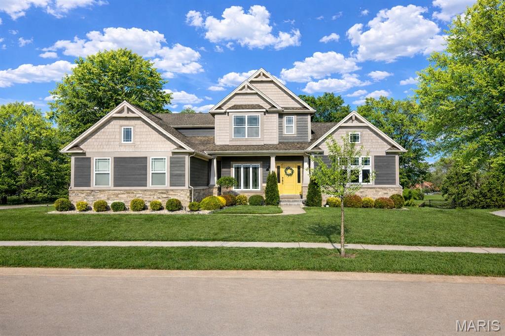 Impeccably upgraded. Perfectly located. Impossible to ignore, where every detail has been thoughtfully elevated and every space feels like it was designed for the way you actually want to live.

Built by McKelvey Homes as part of their prestigious Designer Series, this one and a half story home offers over 4,000 square feet of refined living space, wrapped in a stunning brick-and-stone exterior with James Hardie horizontal cement board siding and pre-finished vinyl cedar shake siding, and a side-entry three-car garage with steel overhead garage doors. Inside, rich hardwood floors, expansive light-filled rooms, and a seamless open layout create an effortless blend of sophistication and comfort. The highly desirable main-floor primary suite offers a huge divided walk-in closet and luxurious ensuite bath, while upstairs you’ll find three additional bedrooms and a spacious Bonus Room, ideal for flexible living. Two bedrooms are connected by a Jack and Jill bath, while the fourth bedroom features its own private ensuite and an upgraded walk-in closet, perfect for guests or extended living.

At the heart of the home, the designer kitchen delivers both beauty and function with upgraded cabinetry, soft-close drawers & doors, solid countertops, walk-in spacious food pantry, stainless steel appliances including a gas cooktop, and a generous island that naturally becomes the gathering place for everything from casual mornings to special occasions.

What truly sets this home apart is the level of intentional, lifestyle-driven upgrades already in place. A 16 x 14 covered composite deck fully screened extends your living space outdoors, offering a peaceful retreat with a backdrop of mature trees. The addition of a swim spa creates a private wellness spa allowing for a competitive water fitness experience, including recovery afterwards right in your backyard, complemented by a surrounding privacy fence for complete seclusion.

Inside, custom touches continue throughout, including a stylish barn door adding character to the office, custom built-in cabinetry that elevates the laundry room, pantry, and primary closet, and upgraded window coverings that add both function and a finished, tailored feel throughout. A whole-house water filtration system with reverse osmosis at the kitchen, along with a whole-home humidity system and air purifier, brings an added layer of comfort and quality to everyday living. Even the outdoor living experience has been refined with a professionally installed irrigation system, concrete patio and steps, lush landscaping, and landscape lighting transforming the exterior into a beautifully curated environment day and night.

For added peace of mind and performance, the home is equipped with a dual-zoned Trane HVAC system, upgraded Timberline 30-year architectural shingles, , and a 75-gallon gas water heater, a large look-out lower level, and is still covered under a 5-year electrical protection plan as well as the 10-year builder warranty. Schedule your showing and come see it for yourself.
