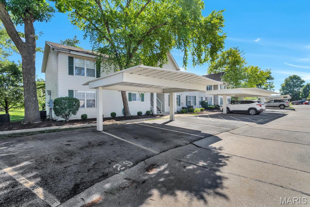Welcome home to this beautifully updated ground-floor condo in the desirable Sugarwood community! Conveniently located in the heart of St. Peters within the Francis Howell School District, you'll enjoy easy access to shopping, dining, parks, and major highways.

This rare floor plan offers the convenience of main-level living plus a full finished basement, providing an incredible amount of living space (~2000+ sq ft). The main level features newer flooring, fresh paint throughout, an updated kitchen with white shaker-style cabinetry, stylish backsplash, and a window that fills the space with natural light. The spacious living room offers luxury vinyl plank flooring and a sliding glass door leading to the covered deck overlooking a peaceful tree-lined setting.

The primary suite features an updated full bath, while a generously sized second bedroom and hall bath complete the main floor. An added bonus is the optional main-floor laundry hookup, which can also be converted into additional closet space since the basement offers laundry hookups as well.

The finished lower level expands your living options with a huge recreation room featuring a bar area, making it perfect for entertaining, a second living area, or guest quarters. You'll also find a full bath, sleeping area with windows, a spacious walk-in closet, and an additional flex room with washer/dryer hookups that would make an excellent craft room, exercise space, office, or additional storage area.

Enjoy being just steps away from the community pool and clubhouse. Monthly condo fees include water, sewer, and trash service, making for easy, low-maintenance living.