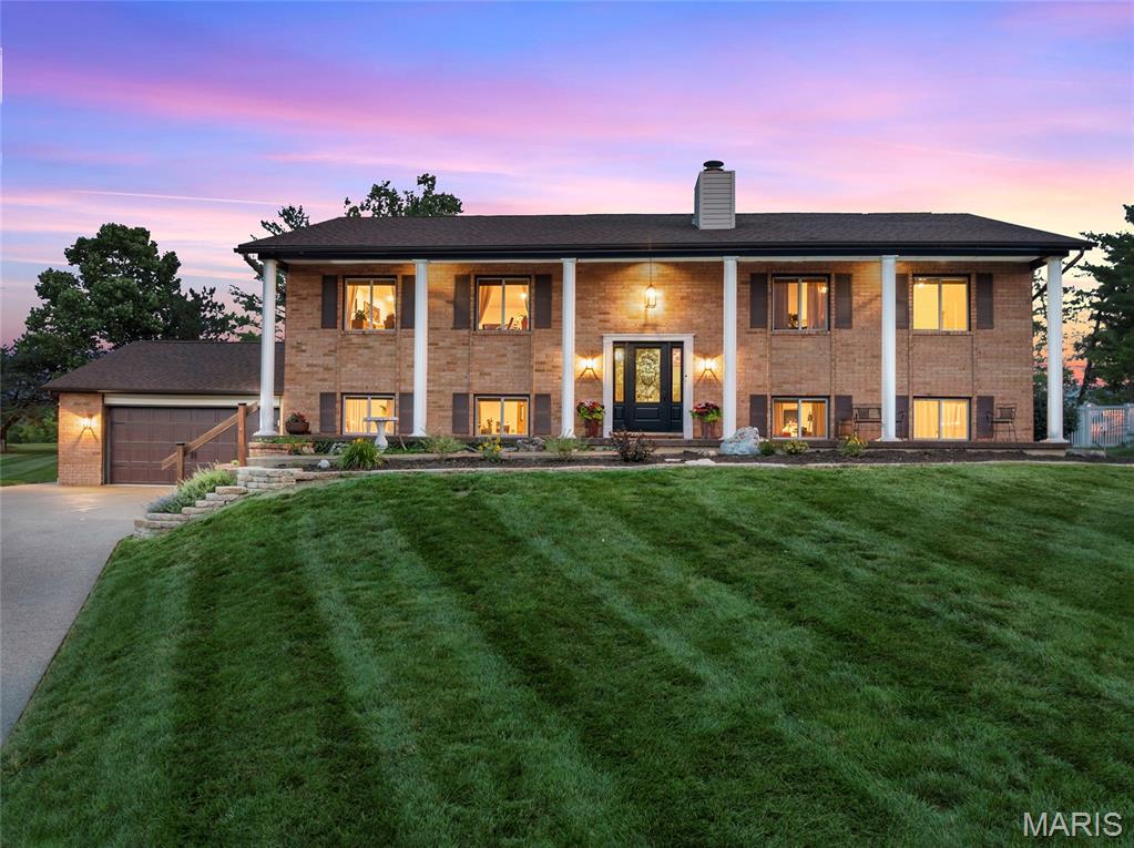 “Living here is like being on vacation every day!” Here’s a rare opportunity to own this exceptional home within the boundaries of the exclusive Lake St. Louis Community Association. Members enjoy lifestyle amenities including two stocked lakes, boating, water skiing, fishing, and beaches in addition to the Clubhouse, restaurant/bar, event space rental, pickleball/tennis courts, olympic size & kiddie pools, golf course, fitness center, pool and lakeside bars, parks, playgrounds and numerous social clubs/activities. Walking and golf cart friendly! Welcome to this tastefully decorated home with its versatile floor plan offering plenty of space and privacy.  Living areas easily adapt to accommodate a home office, a large family or multigenerational household.  Features include 6 bedrooms, three bathrooms, custom kitchen, living room, formal dining room, family room. An 8 car aggerate concrete driveway leads to your outstanding 1,150sq.ft. garage with newer overhead door, resinous surfaced floor, bar and workshop, ready to accommodate multiple cars, boat, golf cart, all your toys! Enter through the newly installed 6 pane glass front door with sidelights flooding the foyer with sunshine! Step into the expansive living room with its cozy wood burning fireplace. Gorgeous remodeled kitchen with Fox Creek custom-made cabinetry, rangehood, island w/built in drawer microwave, Cambria quartz countertop/sink, LG dishwasher & refrigerator w/craft ice maker. Walk out to a generous 36’ X 14’ freshly stained deck. Solid oak flooring throughout the living room, dining room, kitchen, bath, primary bedroom, hallway & stairs. The home’s interior has recently been painted in attractive neutral tones. Luxury vinyl plank flooring flows seamlessly through the entire lower level, which walks out to a large patio. Spacious laundry room with storage galore. Unique in this community, the 1/3+ acre back yard is enclosed by a permitted four-foot vinyl fence with double gate! Systems updates include newer upgraded electric panel and HVAC. Located in the top rated Wentzville R4 School District. Easy access to Hwy 70 and Hwy 40/64 commuting, shopping and dining. Steps away from beautiful Founder's Park. Ready to move in and enjoy all Lake St. Louis has to offer!
