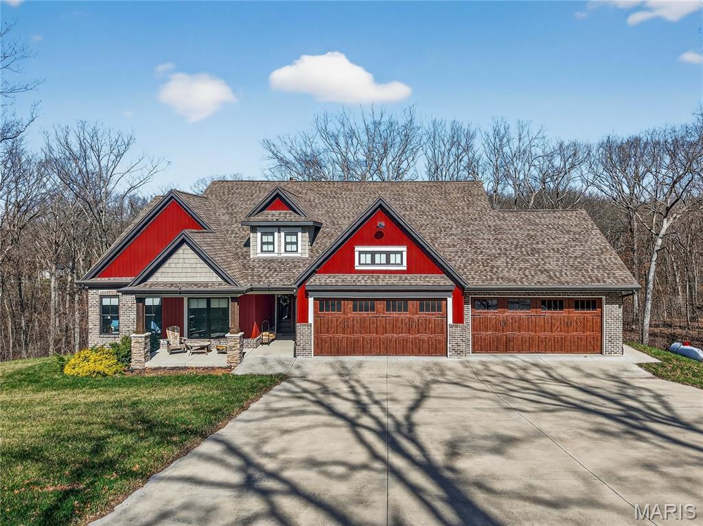 Welcome to this Quality Custom Masterpiece by Arne Homes. You Will Fall in Love the Moment You Arrive.  Blending Architectural Elegance with Serene Privacy. Nestled on a Lush, Wooded 2+ Acre Site, the Home’s Striking Exterior is Accented by Detailed Trim, Architectural Shingles, and a Massive 4-car Oversized Garage. The Welcoming Front Porch Ushers You Into the Open Floor Plan that Feels Truly Grand with 11-foot Ceilings and Upgraded Bronze Andersen Windows that Flood the Space with Natural Light. The Chef’s Kitchen is a Showstopper, Featuring a Gorgeous Oversized Island to Gather Around, Custom Marble Countertops, a Wood Vent Hood, and Stainless Steel Appliances. The Ambiance in the Inviting Family Room is Unmistakable with the Custom Stone Fireplace, Beautiful Built-Ins and Wall of Windows w Transoms. Meander Out to the Screened-In Porch & Adjoining Open Deck For the Ultimate Serene Relaxation in Nature. High-End Finishes Abound, from Luxury Flooring to Custom Crown Molding to Custom Lighting, the List Goes On & On.  Retreat to the Luxury Primary Suite w Elegant Wood Beamed Tray Ceiling, Cozy Fireplace and a Spa-Like Bath, Complete with a Huge Ceramic Tile Walk-In Shower. Convenient Appealing Office Nook Area & Open Staircase to the Lower Level, an Expansive Blank Canvas for Your Dream Finish w Full Size Windows and Walk Out to Patio w Hot Tub.  Every Detail of this 3-Bedroom, 2.5-Bath Home has Been Meticulously Crafted for Those Who Demand Quality and Seclusion. Additionally, the Home is Zero-Entry, Giving Ease of Accessibility Between the Inside and Outside Spaces.  Want a Custom Home Without Waiting For the Building Process, Come Experience a Move In Ready Quality Arne Home for Yourself!