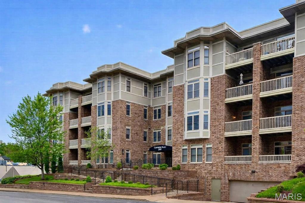 This first-floor residence in the desirable Claymont Place, features a secure lobby entrance, elevator access, and beautifully refreshed common areas. The thoughtfully designed floor plan offers an open living and dining space flowing seamlessly into the kitchen. Wood floors, granite countertops, a breakfast bar, tray ceilings, and fresh paint create a warm interior. A sliding door opens to the private terrace, the perfect spot for relaxation. The spacious primary suite offers two walk-in closets and a bath with dual vanities, a separate shower, and a jetted tub. A versatile second bedroom or study includes an attached full bath, providing comfort and privacy for guests. Convenient in-unit laundry is included, and the washer, dryer, and refrigerator will remain. The garage offers parking space #13 along with storage locker #10. Ideally located within walking distance of restaurants and shops of University City and Clayton, with easy access to major highways. A sophisticated and inviting place to call home.