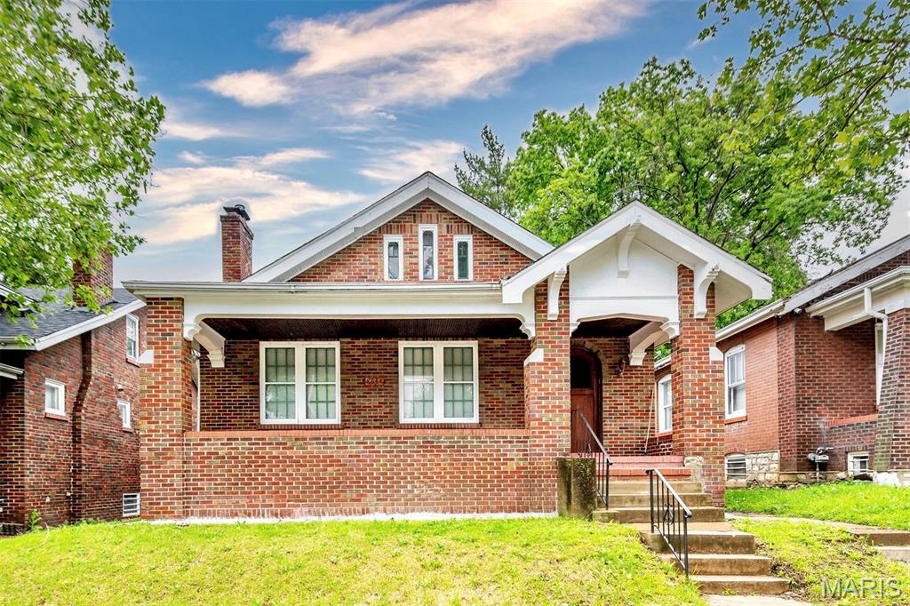 Welcome to this beautiful, all-brick 1.5-story historic home featuring a charming front porch, premium interior finishes, a clean, full basement, and complete move-in ready convenience!

As you step into the grand entry foyer, you will be greeted by a gorgeous, authentic stained-glass window. The expansive living room boasts massive windows that flood the space with natural light, showcasing the gleaming hardwood floors and a cozy wood-burning fireplace flanked by custom built-in bookshelves. The home features timeless architectural details throughout, including elegant arched entries, original arched doors and doorways, premium cherry wood millwork, and matching cherry wood window casings.

The heart of the home includes an updated kitchen complete with gorgeous countertops and beautiful, durable flooring that elevates the entire space. The bedroom features two spacious cedar closets for luxury storage. Head upstairs to find a spacious, massive attic bonus space featuring a comfortable area rug and its own cedar closet! Additional highlights include a fully fenced backyard, a relaxing enclosed back porch perfect for your morning coffee, and a massive, clean full basement providing incredible storage or workshop potential. Don't miss out on this charming St. Louis gem—schedule your showing today!