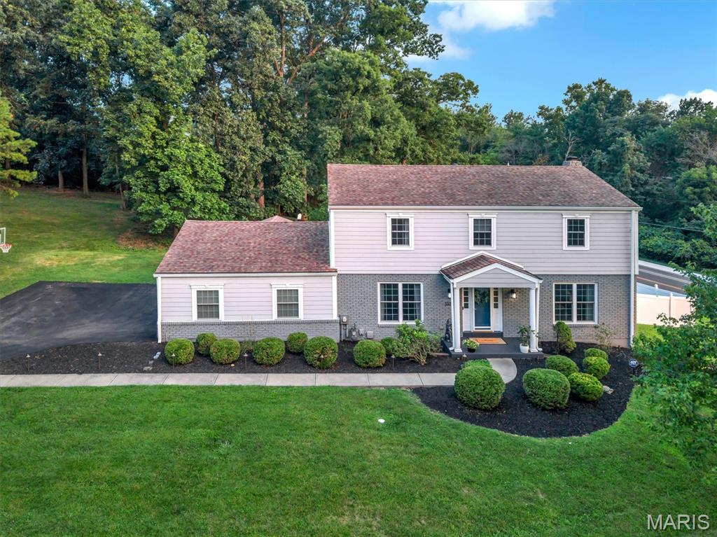 OPEN HOUSE Saturday 7/25 12-2pm! Welcome to this gorgeous 4-bedroom, 2.5-bath home situated on a beautiful 0.72 acre corner lot in the heart of Kirkwood! This exceptional property offers the perfect blend of charm, modern updates throughout and functional living spaces. Step inside to beautiful hardwood floors and an abundance of natural light that create a warm and inviting atmosphere. The spacious family room flows seamlessly into the living room, featuring custom built-ins, a cozy gas fireplace, and a charming bay window, an ideal spot to relax with a good book or enjoy your morning coffee. The beautifully updated kitchen is truly the heart of the home, showcasing a large center island, Cafe appliances, custom wood cabinetry, quartz countertops, abundant storage and a stylish coffee and cocktail bar. Just off the kitchen, the formal dining room provides the perfect setting for family dinners and entertaining guests. Convenience continues with a spacious main-floor laundry room and mudroom located just off the attached oversized two-car garage. Step outside to enjoy the large screened-in porch overlooking the expansive patio, deck, and private backyard offering plenty of space for outdoor entertaining, gardening or simply unwinding in your own peaceful retreat. Upstairs, you'll find three generously sized bedrooms, an updated full hall bathroom, and a spacious primary suite featuring a walk-in closet and a beautifully updated private bath. The partially finished walk-out lower level provides flexible living space ideal for a recreation room, home office, fitness area or playroom with additional unfinished space for storage. Perfectly positioned on a corner lot at the end of a cul-de-sac, this home is within walking distance of Kirkwood High School and just minutes from highways, shopping, restaurants, grocery stores, Kirkwood Park and the vibrant shops and dining of Downtown Kirkwood. This is a home you'll fall in love with. Don't miss your opportunity to make it yours!