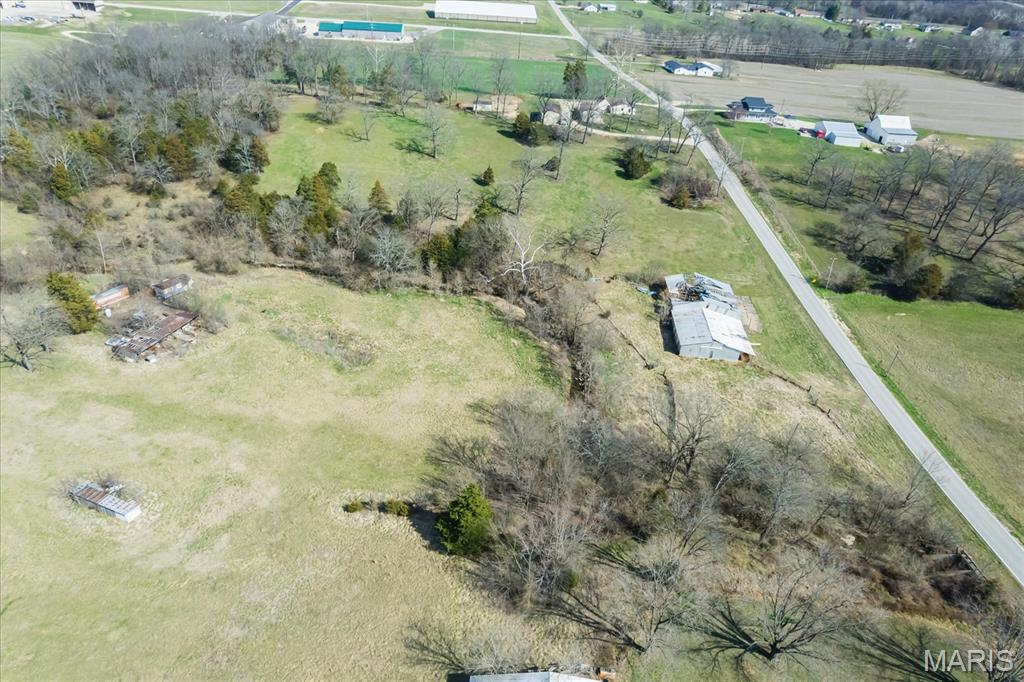 this is  7.33 acres.   Great building property to build your dream home  When you want to build, you will be able to build at the top of the hill and the views will be amazing  You will be surrounded by trees and feel somewhat secluded.  Just think of the views you can see of the stars at night on this love 7.33 acres.   The property had horses in the old barn in the past, so if you want to expand your livestock, its just waiting for you to bring it back to life.  Close enough to town to get to the shopping and restaurants but far enough away to feel the peace and quiet of the country life.