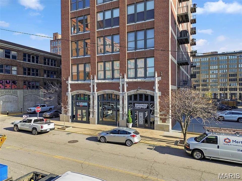 **Home Qualifies for HomeSTL Homebuyer Assistance Program**

Experience downtown loft living in this stylish corner-unit condo located in the sought-after Printers Loft building. This 2-bedroom, 2-bath residence offers 1,244 square feet of thoughtfully designed living space featuring exposed brick, soaring 11-foot ceilings, abundant natural light, and an open loft-style layout. The kitchen is equipped with stainless steel appliances, a gas stove, and flows seamlessly into the main living area and private balcony.

Additional highlights include in-unit laundry with washer/dryer combo included in the sale, a dedicated storage room on the same level, and secure garage parking with one space featuring a lift system allowing for a potential second vehicle.

Residents of the Printers Lofts enjoy premium amenities including a fitness center, rooftop deck, community room, secure garage parking, and guest parking. Ideally situated in the heart of downtown St. Louis, the property is steps from 21C Museum Hotel and minutes from Energizer Park to enjoy CITY SC matches, Union Station and the iconic Gateway Arch.

A rare opportunity to own a true downtown loft combining character, convenience, and walkable city living.