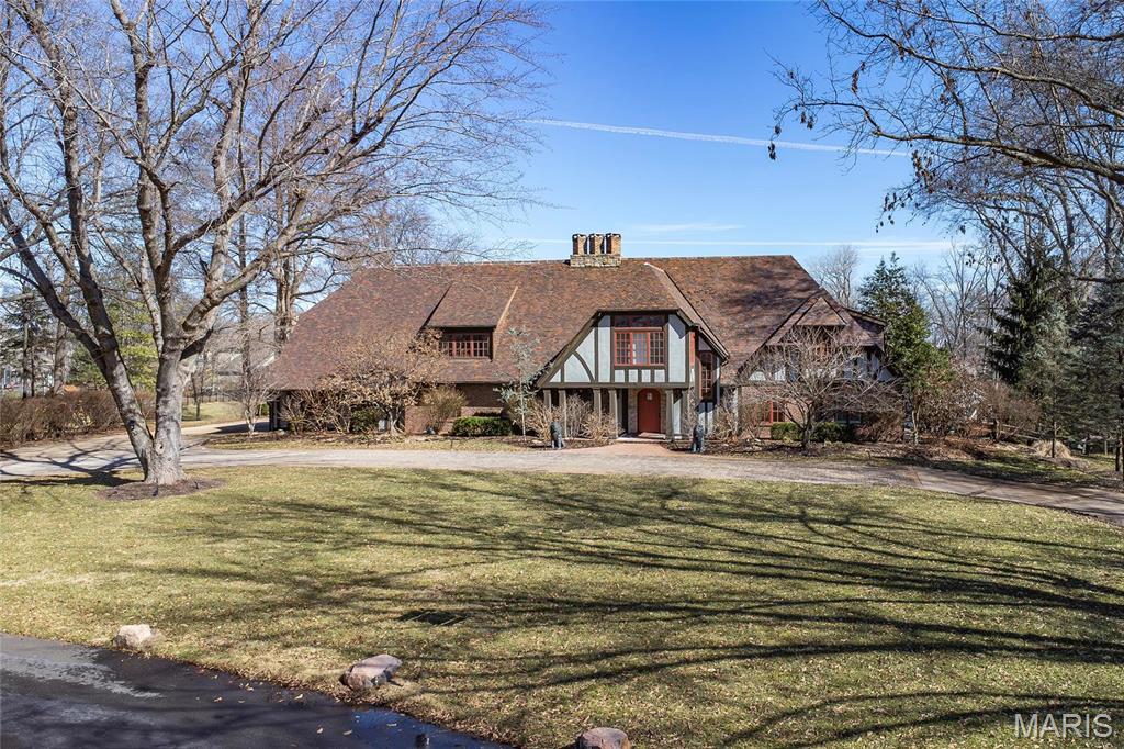 One-of-a-kind English Estate, situated on a spectacular 1.54-acre lot, on a cul-de-sac street, in the heart of Frontenac. Boasting 6 Beds, 4 Full & 2 Half Baths, with 7400+ sqft of total living space including the professionally finished Lower Level. Main Floor boasts an extremely functional, open floor plan with a Living Room, formal Dining, vaulted Great Room with an antique pine ceiling, all opening to the Breakfast Room with stone fireplace. Gourmet Kitchen with custom cabinetry, granite, center island/breakfast bar & top of the line appliances. Main Floor Primary Retreat with a spa-like Bath, including double vanity, custom tiled, multi-head shower & custom walk-in closet. Walk up the artisan, handcrafted staircase to the 2nd Floor with cozy Loft, 4 spacious Beds, all with tons of character & large closets, 3 full Baths & large Bonus Room, ideal for in-law quarters. Relax outside in your private oasis, expansive rear patio, lower-level patio or around the large in-ground pool.