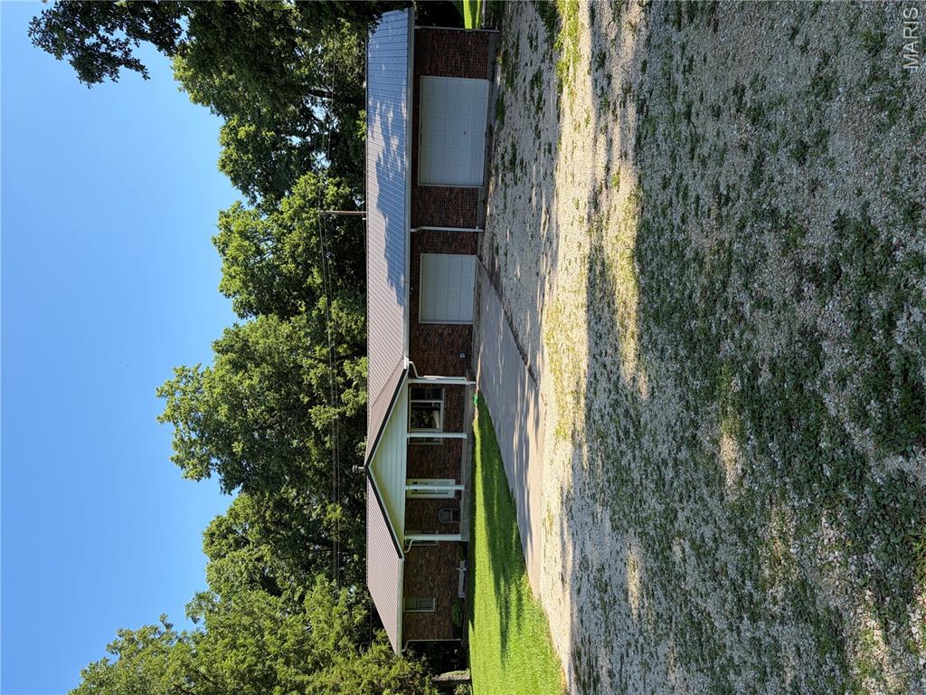 Located on scenic Hwy. 79 this peaceful setting has tons to offer. Gently rolling yard with plenty of shade for your outdoor activities and projects. The hand-crafted cabinets hardwood floors add a unique touch. The spacious all-season room and attached deck gives multiple options on spending your leisure time. The 20x44 pull through garage has multiple uses for your toys or workshop needs. All this and just outside of town. Preapproval for all showings