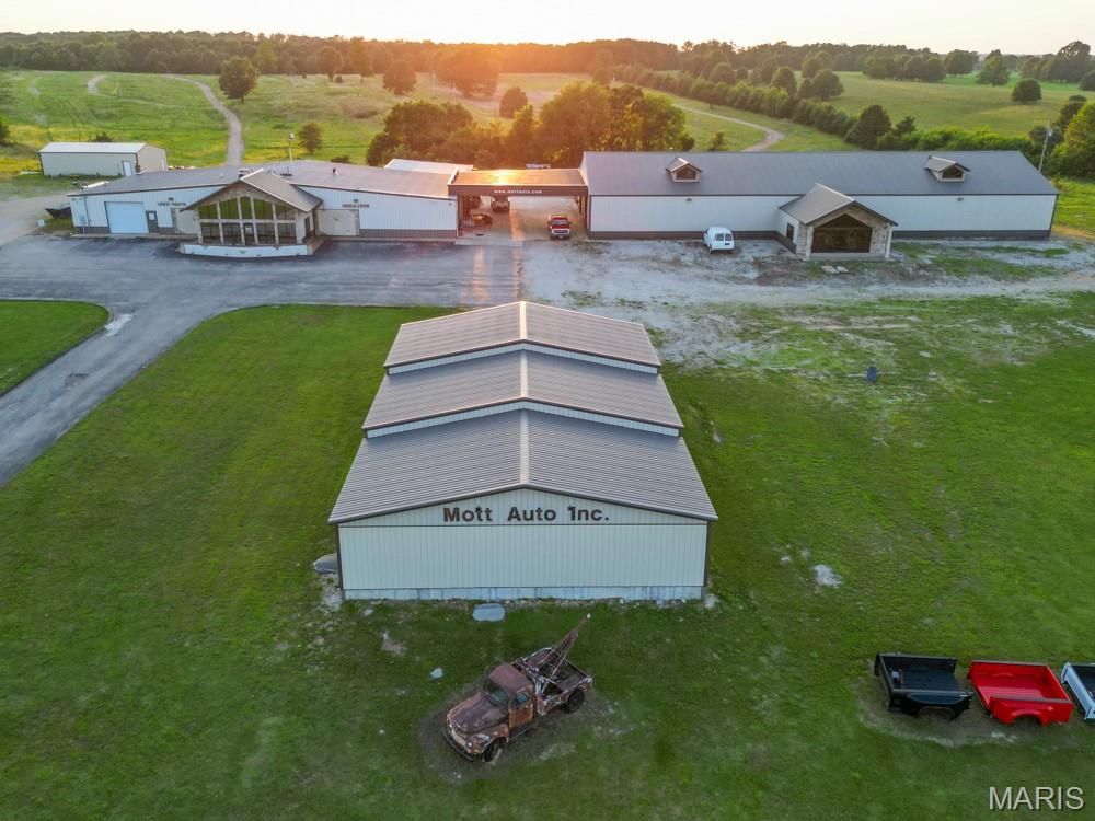 Prime Commercial Property with High Interstate Visibility, Easy Access, and Expansive Facilities on 12 Acres with 1300 Feet of Highway Frontage! Discover a rare and lucrative investment opportunity that perfectly combines visibility, access, and scale in one extraordinary commercial package. The facility is currently operated as Mott Auto Salvage and the owner is retiring and all buildings can be emptied by closing unless another salvage business is interested in the property and contents as a package deal. Situated in a high-traffic corridor with prime interstate visibility, this property boasts approximately 27,000 square feet under roof across four versatile buildings and spans an impressive 12 acres of land with options for more land available if needed. The acreage allows for ample parking, outdoor storage, equipment staging, or future vertical expansion. The zoning supports a wide range of commercial and industrial uses, and there is plenty of room for large vehicles, delivery trucks, and heavy machinery. Landscaping and perimeter fencing options can further enhance security and visual appeal. Location is everything in real estate, and this property offers unparalleled exposure and convenience. Existing structures allow for a fast launch, while the land ensures scalability for future expansion. The site offers a flexible foundation for a wide range of business ventures—from logistics and warehousing to retail, or a multi-use commercial hub.