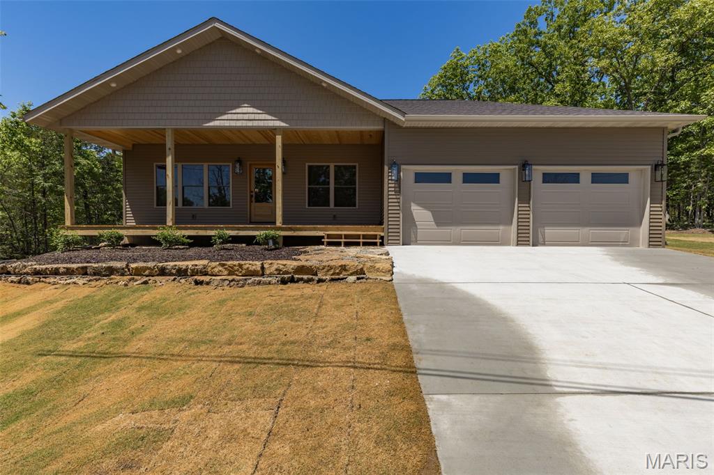 NEW PRICE!!  This beautifully crafted new construction home is packed with upgrades from top to bottom. The builder’s pride shows in every detail — from the 5/8 engineered wood flooring, crown molding throughout, and tall baseboards, to the upgraded carpet and padding in the bedrooms. Even the lighting fixtures were chosen for quality and style, giving the home a warm, finished feel.  The home offers 4 bedrooms (with the 4th featuring custom wainscoting and a built-in desk, perfect for an office), 2.5 baths, and   located next to Lac Lafitte.  The kitchen is loaded with high-end touches including custom cabinetry, quartz countertops, a pot filler, propane 6-burner cooktop, built-in oven/microwave, breakfast bar, and a built-in wine rack.  You’ll love the spacious laundry room with built-in cabinets and a folding counter, plus a handy mudroom drop zone with bench seating and hooks right off the garage. The living room features a cozy propane fireplace, and the 9-ft ceilings add an open, airy feel throughout the main level. The oversized 2-car garage offers 11-ft ceilings for extra storage.  Outside, the fresh Bermuda baseball sod and landscaping lead you to a welcoming covered front porch — the perfect spot for morning coffee or evening tea. The backyard includes a natural rock firepit area, ideal for gatherings, plus a covered side patio ready for your BBQs.  Quality, comfort, and thoughtful design come together beautifully in this home.