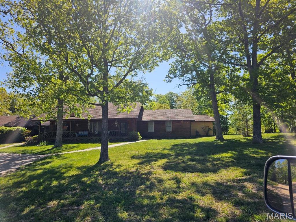 Come see this beautifully landscaped home sitting on 21 m/l acres. Property has a stocked pond with a gazebo overlooking it, lots of fruit trees, 2 nice garden spots,  There is fencing for your animals and a  1080 sq ft barn to keep them in. Behind the garage is a greenhouse. Lots of room for all your toys and equipment in the garage.  The home has 3 bedrooms and 2 full baths.  There is an open concept in the kitchen, living room, and dining room. There are high ceilings covered in wood. Kitchen has a center island , lots of  custom cabinets and all new appliances. Huge master bedroom with master bath a large walkin closet. Outside there is a covered front porch and a covered patio on the back. Great spot to sit and watch nature around you.