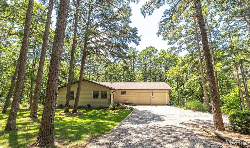 Charming Home on 11 Acres with Towering Pines – Texas County, MO. This peaceful 11-acre property offers the perfect blend of seclusion and convenience. Located in the heart of scenic Texas County, the 3-bedroom, 2.5-bath home is surrounded by towering pines and a quiet, wooded landscape that feels like your own private park. The home features a warm, comfortable layout with three main bedrooms and an additional non-conforming room that could serve as a fourth bedroom, home office, or hobby space. A fully finished walk-out basement adds extra living space and opens up to a spacious back porch—perfect for entertaining or simply enjoying the peaceful mornings. Outdoors, the tall pine trees create a beautiful backdrop and offer a serene, natural setting. Wildlife is abundant here, with regular visits from deer and turkey, making it an ideal spot for hunters or anyone who enjoys the outdoors. You'll find ample outdoor seating that overlooks your own private canyon filled with giant boulders and mature pine trees—a truly unique and scenic view. Just a short drive from the Big Piney River, you’ll have easy access to fishing, kayaking, and other recreational activities on the water. Whether you're searching for a full-time residence or a weekend retreat, this property checks all the boxes. Come see it for yourself—schedule your private tour today.