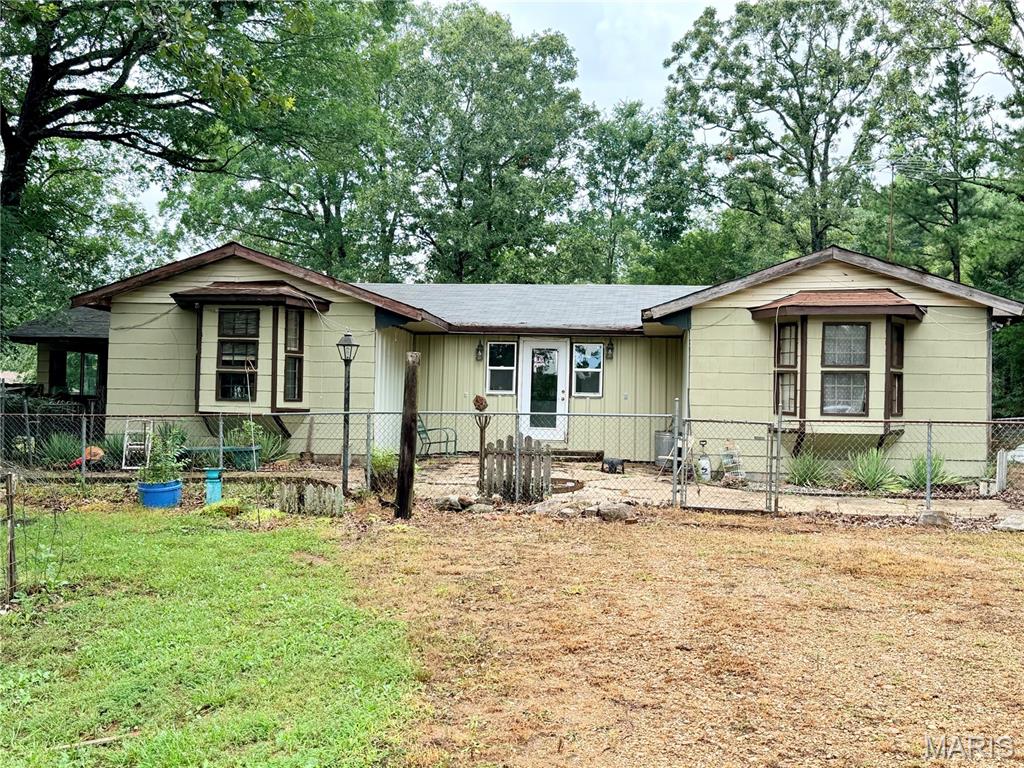 Escape to tour your own Ozark retreat! Nestled on approximately 20 acres, this custom hand-built home offers the peace, privacy, and beauty that country living is all about. Tucked away from the highway, you'll enjoy a quiet setting with thick natural bedding cover perfect for an ideal wildlife habitat, and plenty of room to roam. Whether you're looking to raise a family, start a homestead, or simply enjoy the outdoors, this property offers endless possibilities. Outdoor enthusiasts will appreciate the excellent habitat for whitetail deer, turkey, and other wildlife. Relax in the massive sunroom wrapped in picture windows while observing the abundant wildlife and views in the peaceful Ozarks. Two-pole barns and an additional storage shed provided ample space for equipment, hobbies, or livestock. Conveniently located just a scenic 15-minute drive from Doniphan through beautiful farm country, this property offers the perfect blend of seclusion and convenience.