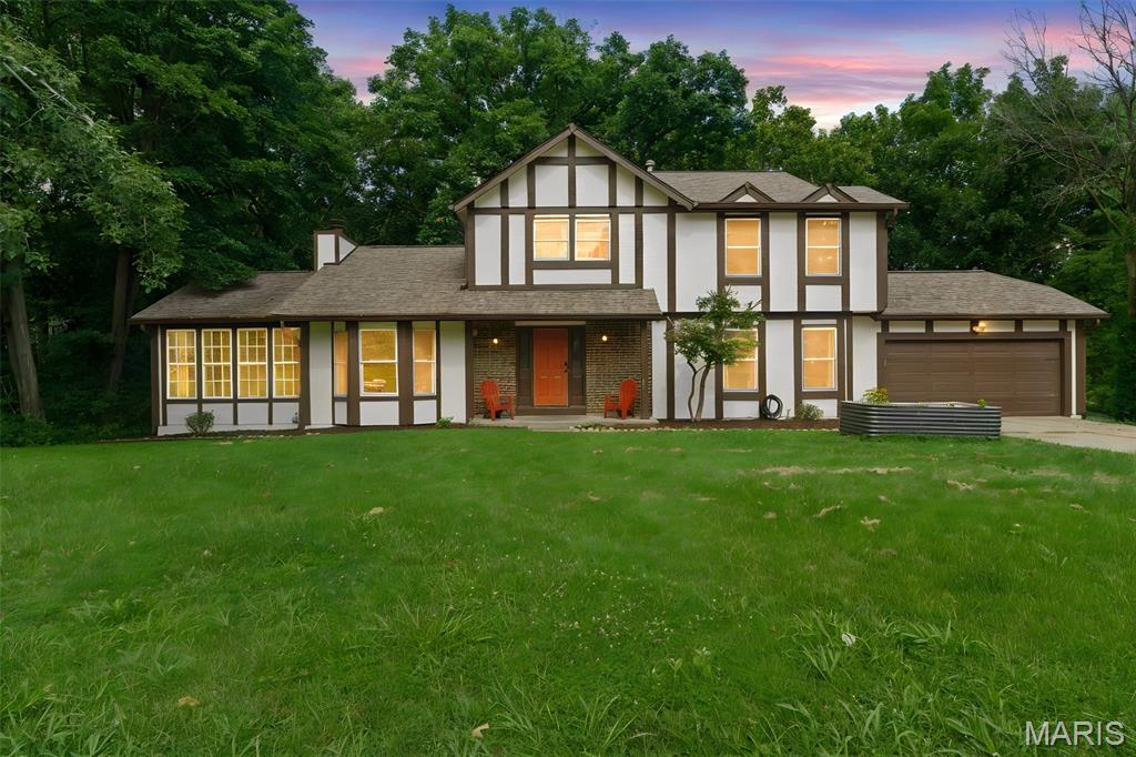 The Craftsman style woodwork is sure to impress in this Tudor Style home that is situated on a large private lot right in desirable Timberidge neighborhood in the heart of St. Peters.  Located in Francis Howell Schools and close to highways and shopping, there is much to love about this home! Custom details throughout include oak wainscoting in the large entry. Solid oak floors throughout the main level.  The Kitchen has beautiful custom crafted walnut counters and is open to the Breakfast room. The spacious Living Room with a fireplace and recessed lighting walks out to the semi covered deck that has a lovely wooded view. The additional Sun Room is amazing and located right off the living room. A Flex Room and half bath complete the 1st floor.  As you go upstairs, there is a custom walnut balustrade in the mid-century style and the oak floors continue up the stairs & the 2nd flr hallway.  There are two large secondary bedrooms & a remodeled full bath.  The Primary Suite is so spacious w/ an oversized shower, custom pecan cabinetry, granite counters.  The walk out basement is ready for your finishing touches! There is so much to love about this home!
