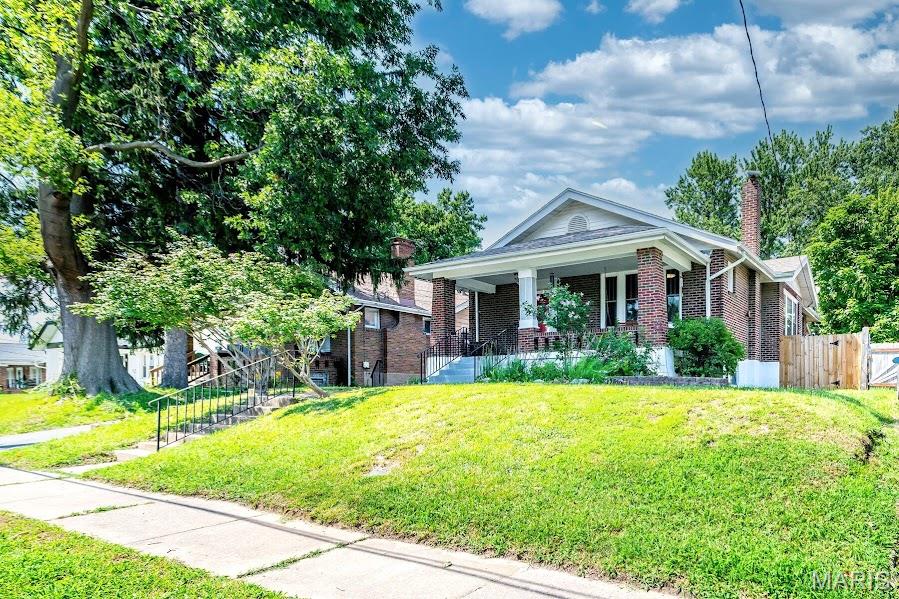 Lovingly maintained and full of timeless charm, this inviting 2-bedroom, 1-bath bungalow offers over 1,300 square feet of comfortable living space. From the moment you arrive, you'll appreciate the pride of ownership that shines throughout, blending classic character with thoughtful updates and everyday comfort.

Inside, warm wood flooring, abundant natural light, and charming architectural details create an inviting atmosphere you'll love coming home to. The spacious living and dining areas flow seamlessly together, making the home ideal for both everyday living and entertaining. The kitchen offers stainless steel appliances, generous cabinet and counter space, and an adjoining mudroom with convenient access to the backyard.

Step outside to a large deck overlooking the level, fully fenced backyard—perfect for relaxing, entertaining, pets, or gardening. The yard offers plenty of usable outdoor space without the upkeep of large mature trees, allowing you to spend more time enjoying it and less time maintaining it. The sellers have also completed spot tuckpointing to help preserve the home's beautiful brick exterior.

The lower level features beautifully painted floors and provides flexible space ready to fit your needs, whether you're looking for a recreation room, home gym, workshop, hobby space, or additional storage. Conveniently located in the heart of Overland within the Ritenour School District, this home offers timeless charm, a functional layout, and the peace of mind that comes with years of attentive care.