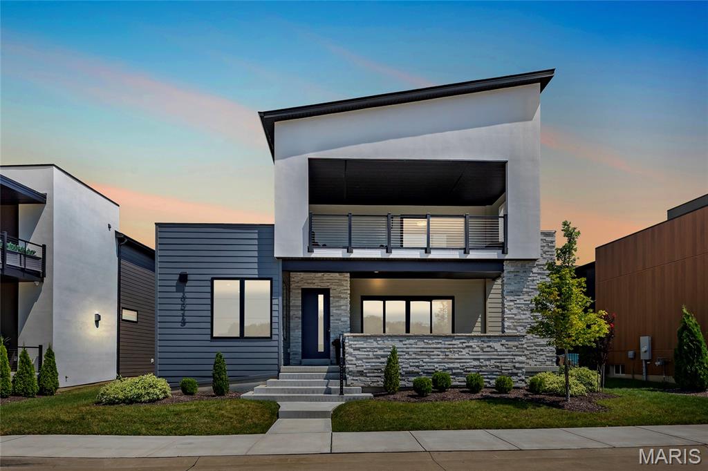 Fantastic, less than 2-year-old home, in the most unique development in St. Louis, Chesterfield Waterfront at Wildhorse Village.  This custom-built 1.5-Story home with an open floor plan is a must-see. 5 Beds, 5 Baths (4F/1H) and over 4,500 sqft of living space, including sunlit open floorplan with 10' ceilings, wide plank flooring, all with incredible lake views.  The amazing outdoor living space is made up of a front lanai with 12' sliding doors, a covered 2nd floor deck, and another 12' sliding door from kitchen opening to the courtyard with stone pavers.  Enter the home from the lanai leading to the entry foyer and separate office, with French doors, opening to the great room with tiled floor-to-ceiling gas fireplace with metal hearth opening to dining room and Kitchen with GE Cafe appliances, solid surface countertops, custom cabinetry, large island with seating.  The main floor primary suite has a spacious walk-in closet and large shower, a separate standalone tub, double vanity with backlit lighting. Additional first floor features include a 1/2 bath and large laundry, and work area.  Open staircase leads to 2nd Floor with 3 Bedrooms, one, a secondary suite, with large en-suite bath, and 2 other bedrooms with large, shared bath, and bonus room that walks out to covered deck with spectacular lake views.  Lower Level has fantastic finished space, and bedroom with full bath. Relax outside in your private oasis. Some remote window treatments, irrigation system, lawn care and landscaping, and 3-car garage. This development is never-before-seen in St. Louis, with walking paths, 2 lakes, premier dining and shopping within minutes, and Easy highway access. This is a lifestyle of unparalleled luxury, comfort, & convenience.