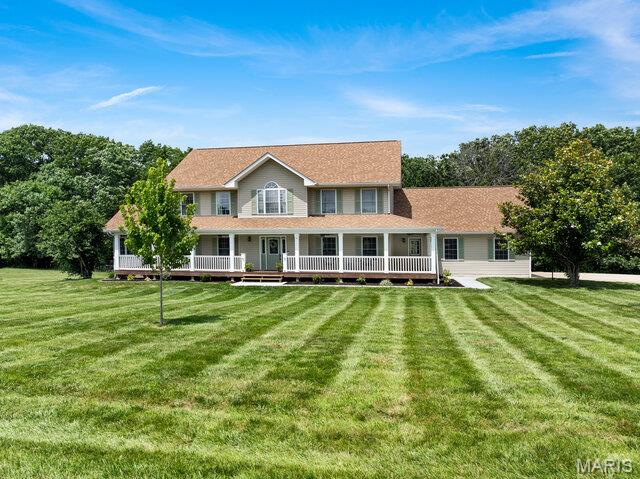 Beautifully remodeled two-story home offering over 3,400 square feet of finished living space on 5 picturesque acres with a shared lake. This spacious home features 5 bedrooms, 3.5 baths, and an incredible primary suite with a luxurious, fully remodeled bathroom.  This main floor primary suite is 16x15 features coffered ceilings, luxury bath with dual vanities, new soaker tub, separate shower w/custom tile surround & custom glass enclosure & large walk in closets with custom shelving. The entire home has been thoughtfully updated, including a remodeled split staircase, fresh paint throughout, beautifully updated bathrooms, a brand-new deck, new sidewalks, landscape curbing, and newly planted trees that enhance the property's curb appeal. Inside, you'll appreciate the natural light & abundance of closet space and storage throughout the home. The stunning kitchen is designed for both everyday living and entertaining with 42" Amish custom-built cabinetry, a newer  tile backsplash, stainless steel appliances, double wall ovens, a large center island, walk-in pantry, and new luxury vinyl plank flooring throughout the main level. The spacious main-floor laundry room offers convenient access to the new deck. The living room is filled with natural light from the triple bay window & features a cozy electric fireplace. Upstairs, you'll find four additional generously sized bedrooms all with large closets and a full bath, providing plenty of room for family or guests and a cozy sitting area. The walk-out lower level includes a full bathroom, french doors to your huge patio, 4 egress windows, completely framed in & some electric has been ran & is ready for your finishing touches, offering endless possibilities for additional living space, a recreation room, home gym, or guest suite. Other features include 3 car garage is finished with insulated garage doors & dual geothermal units & newly paved road. Located on a quiet 5 acres with an above ground pool & shared laked tucked away in your back yard.  Just 12 minutes from I-70 in Warrenton, this exceptional property offers peaceful country living with an easy commute to both St. Louis and Columbia. This move-in-ready home truly has the space, updates, and setting you've been looking for!