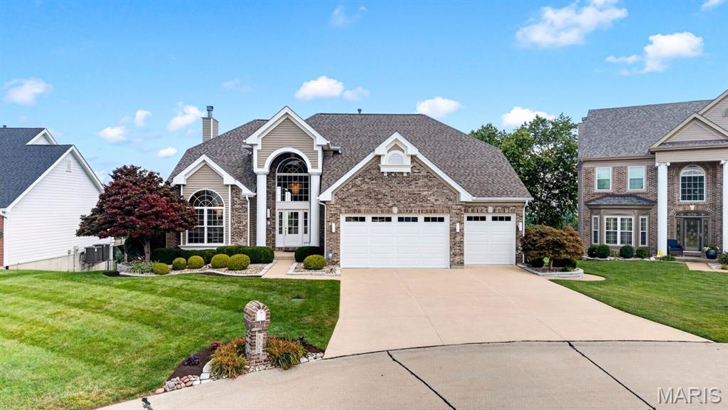Commanding a premier bluff-top setting with panoramic views stretching for miles across the Mississippi River Valley, this exceptional residence offers a rare blend of elegance, comfort, and natural beauty. Located in desirable Fordyce Bluffs, the impeccably maintained 1.5-story home welcomes you with a dramatic two-story foyer and elegant staircase, while the formal dining room framed by graceful archways and columns creates a stunning setting for entertaining. The soaring great room showcases hardwood floors, crown molding, a gas fireplace, and a spectacular wall of Palladian windows that flood the home with natural light while framing the breathtaking scenery. The open kitchen features newer stainless steel appliances, abundant white cabinetry, a spacious wraparound peninsula with breakfast bar seating, and an adjoining breakfast area with seamless access to the glass-railed deck. The main-floor primary suite offers a walk-in closet and luxurious bath with dual vanities, soaking tub, and separate shower. Upstairs includes a Jack-and-Jill bedroom layout plus an additional spacious bedroom with a private ensuite bath. The finished walkout lower level provides extensive living and entertaining space, including a large recreation area, full bath, storage space, and a four-season room that opens to an expansive patio. Beautifully landscaped and meticulously cared for, this home also features a 3-car garage and extensive 2025 updates, including a new roof, gutters, fascia, siding, front door, garage doors, and stainless steel kitchen appliances. Whether enjoying sunrise coffee on the deck, hosting gatherings on the patio, or unwinding in the comfort of the four-season room, the ever-changing valley views create an extraordinary backdrop that can be enjoyed every season, every day of the year.