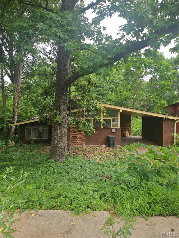 Popular Webster Groves location.  If you are looking for that fixer upper, this is it.  Must see to believe this great lot and the possibilities that it holds.  Could be your new home site (with governmental  approval) Detached studio located at the rear of this wooded lot. Property is being sold as is.  Please use Special Sales Contract.