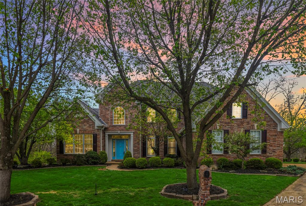This is West County living at its finest. Tucked away in the Wynncrest neighborhood on a quiet cul-de-sac and backing to woods, this 5-bedroom, 6-bath home offers nearly 7,000 sq ft of thoughtfully designed living space with a rare sense of privacy.

A stunning elevation welcomes you into a soaring foyer, flanked by a formal dining room and private study. Just beyond, the sun-drenched two-story great room makes an immediate impression with gleaming hardwood floors, a beautiful fireplace, and a wall of windows that brings the outdoors in.

The kitchen is designed for both everyday living and entertaining, featuring granite countertops, stainless steel appliances, custom cabinetry, and abundant workspace. An oversized breakfast area flows seamlessly into the hearth room, creating a warm and functional gathering space. A convenient half bath and main floor laundry are just steps away.

The main-floor primary suite offers a true retreat with its high ceilings, spacious walk-in closet, and beautifully appointed bath. Upstairs, you’ll find three generously sized bedrooms, two full baths, and a versatile loft space.
The finished 9 ft pour lower level expands your living space with a full bar, theater area, additional bedroom, and plenty of room for recreation, hobbies, or guests.

Step outside to a private, park-like backyard surrounded by mature trees. A stone patio and tucked-away fire pit in the woods create a setting that feels both peaceful and memorable.

Additional highlights include a new roof (2025), new water heaters (2026), 3-car garage, full gym space, and a location close to everyday amenities.

If you’re looking for space, privacy, and a home that truly lives well, this is one worth seeing.