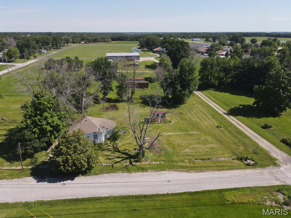 It is hard to find city lots! They are in high demand and rarely hit the market, so don't let this oversized 150x137 level lot pass you by.  Located on the north side of Kahoka along Grant St, the lot is tree lined on the west & north sides, with street frontage to the south & east.  This provides multiple building-site options or bring your ideas and renovate the 881 sq ft bungalow that is ready for your finishing touches. Offering a nice layout, 2-beds, 1-bath, a sunny kitchen and spacious living & dining rooms - there is definitely potential here! There is a partial basement, forced air furnace and window-unit air conditioning. Homes in this price range do not come along often, and after renovations your home equity will be drastically different.

Utility providers here include city electric, water, sewer, trash, Liberty Gas, and Rise Fiber is available.