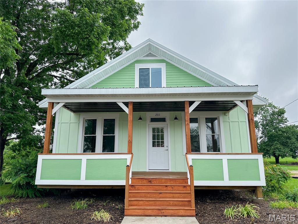 This 3 BR, 2. 1/2 BA,  has lovingly been restored to her original glory.  Owners did not finish the kitchen and 2 full bath so that you can make it your own. Living room, dining room and bedrooms have original wood floors.  The following is NEW on and in the home.  R-22 radiant barrier under the new metal roof, siding, front porch. New electric, water lines, water heater, central air and new central electric furnace.  Also, new blower on the wood burning furnace if wood heat is your preference.  All modern windows, garage door.  The home has approximately 1730 sf living area.   Detached garage -  all sitting on a beautiful tree shaded 1 acre lot.  (ml)   The stately pecan tree is just gorgeous.  Come take a look....