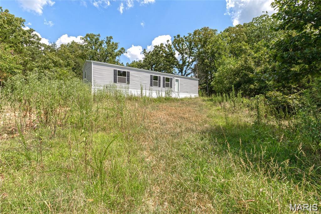 If you are looking for a piece of country paradise for an outstanding price- look no further! This expansive property on 10 acres is a prime opportunity with an option to purchase additional connecting acreage. Located just under an hour from Lake Ozark, ˜30 minutes to Ft. Leonard Wood, and only ˜10 minutes to I-44. Pull into the elongated driveway offering plenty of privacy to find a nearly brand new mobile home, ready for your personal touch! Indoors, you'll find an ensuite bedroom/bathroom, with a second bedroom and bathroom on the opposite end of the home. The open concept kitchen/dining space includes an island, modern fixtures, and plenty of natural light. Don't wait! Schedule your personal tour today!