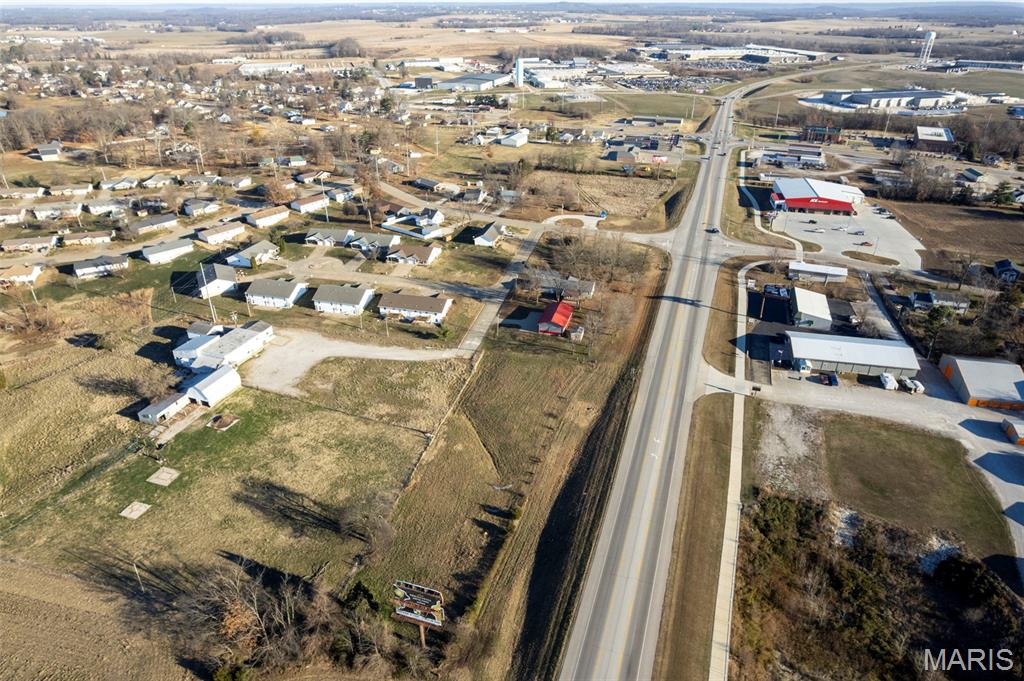 Position your business for success with this exceptional C-2 zoned 2.26-acre property offering highway frontage, strong visibility, and steady traffic flow along the Highway 51 corridor. Located in an area experiencing recent development, this site is well-positioned for continued commercial growth and accommodates a wide range of potential uses. The property includes a 1,727 sq ft, 3-bedroom home with a full basement, providing flexibility for owner occupancy, office conversion, or on-site operational space during future development. Also included is a 30x56 fully insulated metal outbuilding, constructed in 2018 by Ponder Built, featuring 12-foot ceilings, insulated overhead doors, concrete floor, metal-lined interior, bathroom with slop sink and toilet, permanent automotive lift, air compressor with plumbed air lines, and 3.5-ton HVAC unit with dehumidifier for year-round climate control. This building is potentially suited for a variety of commercial operations.  An existing billboard lease adds additional income potential. With its strong exposure, zoning, and versatile improvements, this property offers an outstanding opportunity for investors, developers, or owner-users seeking a high-visibility commercial site along a proven corridor. Duplicate listing 25080826