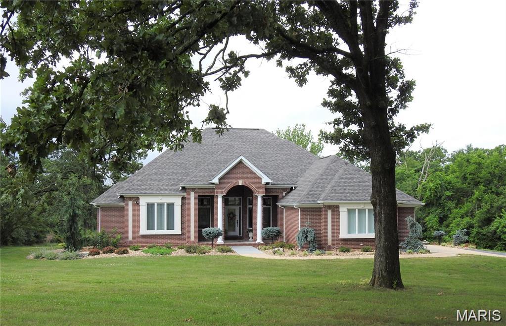 All Brick home w/ over ~5100 SqFt has many custom features. Large eat in gourmet kitchen w/ granite counters, center island, stainless steel appliances/double oven. Large screened 19x15 sun-room. The living room has a fireplace, 12' ceilings & windows overlooking landscaped backyard. The master bedroom features a tray ceiling & french doors opening to master bath w/ double vanities, jetted tub, walk-in shower w/ two shower heads & large walk in closet. The walkout basement includes a game area/family room w/ a fireplace & large bedroom. Outside garage is plumbed, heated and is ~20x30 sqft.  
Updates 2020/2021: Remodeling included installation of a new vented high quality propane fireplace insert by Forshaw of STL w/ custom ordered/designed stacked stone, Fireplace adorned w/ specialized hammered/forged steel front. Installed all new Bruce hardwood flooring on main level. New appliances include cooktop & Samsung refrigerator.