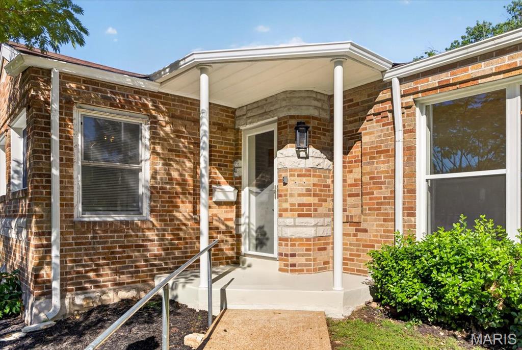 Beautifully updated and move-in ready, this charming brick bungalow sits on a quiet cul-de-sac in Bella Villa and offers the perfect blend of character and modern convenience. Inside, you'll find beautiful hardwood floors, abundant natural light, a spacious living room anchored by a stone wood-burning fireplace, and a beautifully renovated kitchen featuring white cabinetry, stainless steel appliances, and generous prep space. The bright sunroom addition provides the ideal flex space for a home office, reading room, or morning coffee retreat. The fully remodeled bathroom showcases timeless finishes, while two comfortable bedrooms and tasteful updates throughout make this home truly turnkey. Outside, enjoy a large level yard, mature landscaping, and excellent curb appeal. The full basement offers exceptional storage and future finishing potential, along with a tuck-under garage.