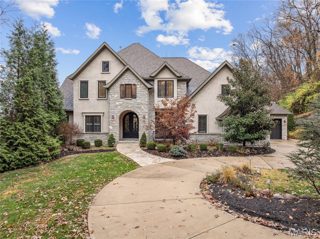 Private 2 acre estate in the heart of Chesterfield! Tucked away out of sight of neighbors, this beauty is ready for a new owner. Step off the circle drive into the arched, steel, double door entry. A formal office with glass doors for privacy is the perfect WFH set up. Watch the seasons change in your 2 story great room with gas fireplace, built in bookshelves and view to the covered deck. The seller spared no expense in this custom kitchen with built-in Thermador refrigerator, gas range, prep sink, double oven and walk-in pantry with custom shelving. The main floor owners retreat provides a tranquil space with bay window and tray ceiling. The en-suite bath includes dual sinks, free standing tub, oversized shower and access to the walk-in closet. Upstairs you'll find three large bedrooms, all with walk-in closets. Both bathrooms- the en-suite and jack and Jill- are beautifully outfitted. The second floor oversized bonus room is the perfect hang out space. The walk-out lower level is ready for finishing with plumbing for a full bath AND a powder room. If your dream is to have a pool, the level lot is perfect for your outdoor oasis. The home is equipped with a 400 amp service.  Additional upgrades include: central vac, irrigation, landscape lighting, Lutron switches throughout, 3 zone HVAC.