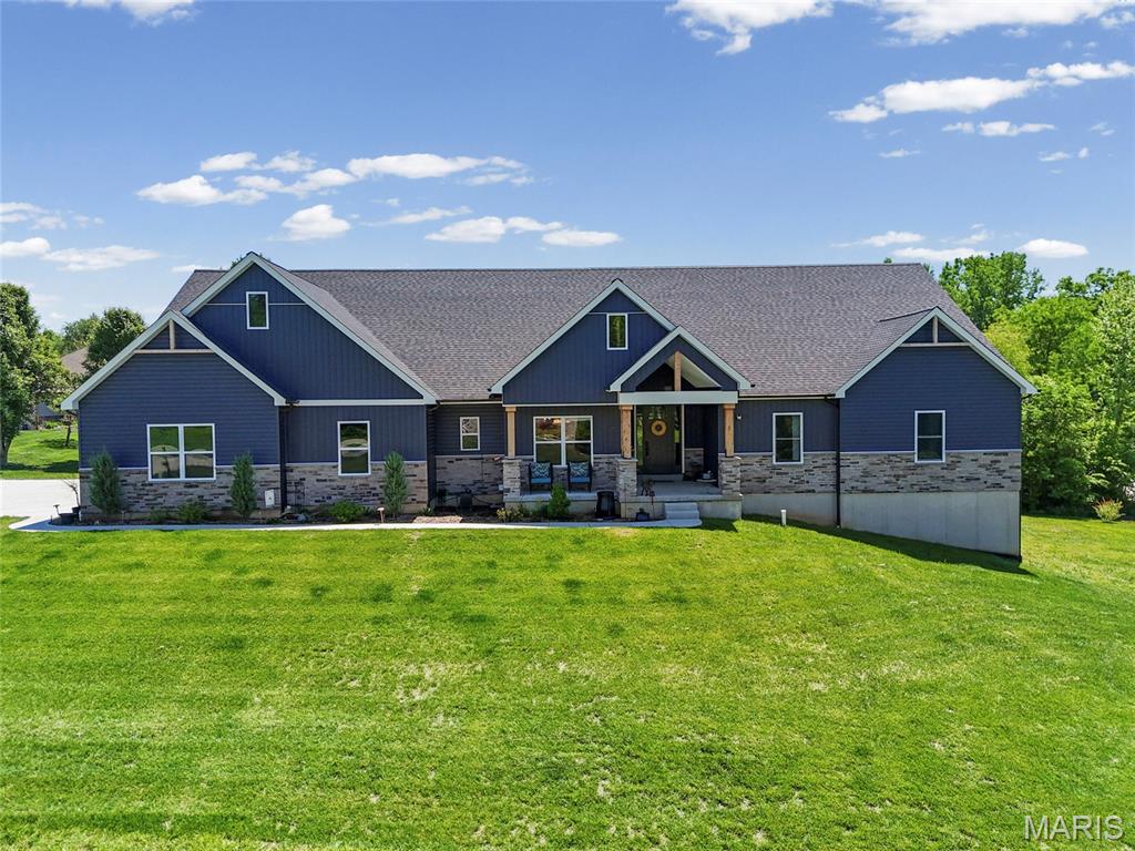 Amazing Ranch home with In-Law quarters, 4+ garage space, 28x53,' with more extras than you can imagine.  Enter the foyer through a custom 8' front door with side window panels to the open floor plan, spacious and elegant living room with vaulted ceiling, a wood-burning stone fireplace, floor outlets, and access to the covered porch area.  The huge kitchen with a center island/breakfast bar, modern lighting, lots of 42" cabinets with crown molding, leathered granite countertops, a custom range hood, a copper farmhouse deep sink in the island, drawers for your pots & pans, recessed lighting, and custom lighting over the island, matching white appliances, including a fridge, dishwasher, built-in convection microwave, and range. Custom range hood over the induction range, additional copper sink on the coffee bar, and a huge pantry with custom shelving (no wire shelves here), and room for all your appliances with extra outlets. The separate dining area is spacious with custom lighting. Travel to the main-floor laundry, which features multiple electrical outlets for all your appliances, a storage cabinet, and shelving. The secluded primary bedroom is large with carpeting, a large picture window, large walk-in closet with custom shelving. The beautiful primary bathroom features an oversized walk-in shower with a bench, custom glass shower doors, modern lighting, two independent vanities, a linen closet, and lots of storage.  On the opposite side of the house is the in-laws' quarters. It has an independent kitchen area, stainless steel fridge, and custom cabinets, as well as separate HVAC and water heater. The walk-in & oversized shower has custom glass doors, an oversized bench, and is accessible with a laundry area, a walk-in closet with custom shelving and a pocket door, and walk-out sliding glass door to the covered patio.  There are two additional bedrooms on the main floor, each with a walk-in closet, and another full bath.  Eight-foot, 2-panel doors with black-finish hardware and modern lighting, ceiling fans, and luxury vinyl flooring throughout.  The garage is 53 x 28, drywalled, with extra power sources for all those power tools, and has 3 oversized garage doors w/openers, a side entry with extra parking spaces, extra storage racks, and a workshop area. Let's go down to the lower level with iron spindles and an oak post. The lower level is an open landscape with a 9-foot ceiling, a full bath already finished, walk-out access, and room for an additional bedroom plus an additional room reinforced for safety, a water softener system, 2-200 amp service + 100 amp sub panel, a covered back porch, and so much more. The landscaped .92-acre lot in a gated community. Hardy Built home, 1-year-old home with fantastic quality and beauty. Other perks are extra outlets for the covered porch, front soffits for outside lights, and near the mantel. Two independent HVAC units, two water heaters, 4 garage spaces, all under 1 beautiful roof.  All tucked back less than a mile off Old Lemay Ferry in a 28-home subdivision with gated entry just 1-1/2 minutes off Hwy 21, minutes to Hillsboro schools, dining, and shopping. Come visit today. Showings start Friday, May 15.