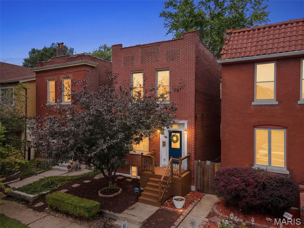 Just steps from Tower Grove Park, this beautifully updated 3-bedroom, 2.5-bath home blends timeless St. Louis character with modern convenience. Inside, you'll find soaring ceilings, exposed brick, rich engineered wood flooring, arched openings, and abundant natural light that create a warm and inviting atmosphere. The dining room is anchored by a decorative fireplace, while the spacious living room flows seamlessly into the updated kitchen featuring granite countertops, stainless steel appliances, abundant cabinetry, a built-in beverage station, and a convenient main-floor laundry room with a half bath. Upstairs, the generous primary suite offers a custom walk-in closet and an ensuite bath complete with dual vanities, a soaking tub, and separate shower. Two additional bedrooms and a full hall bath provide plenty of space for family, guests, or a home office. Major mechanical updates provide added peace of mind, including a new flat roof (2022), zoned heating and cooling with one HVAC system replaced approximately two years ago, and a water heater replaced approximately two years ago. Step outside to enjoy a spacious deck overlooking the concrete patio and fully fenced backyard with mature trees and charming brick pathways, offering multiple outdoor spaces for relaxing and entertaining. A rare bonus for the neighborhood, the rear portion of the lot offers ample space to add a generous parking pad, carport, or future garage, with the current owners utilizing the rear access for off-street parking. Located in one of St. Louis's most desirable neighborhoods, you'll enjoy easy access to Tower Grove Park, the Missouri Botanical Garden, South Grand dining, coffee shops, and neighborhood favorites. Historic character, thoughtful updates, modern mechanicals, and an unbeatable walkable location make this one you won't want to miss.