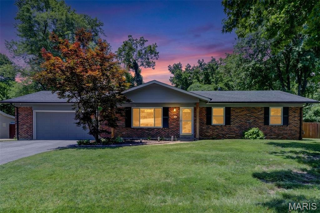 Welcome to 18 Twin Oaks Drive, where timeless charm, exceptional care, and thoughtful updates create a home that's every bit as inviting as it is beautiful. Nestled on a picturesque 0.412-acre lot backing to mature trees, this move-in ready ranch offers over 2,200 square feet of finished living space, 3 bedrooms, 2 full baths, a beautifully finished lower level, and the privacy you've been searching for.
Outstanding curb appeal sets the stage with fresh exterior paint, newly painted shutters, front door and trim, and recently repaved driveway.  Step into the backyard and you'll discover your own private retreat—with and a stylishly renovated deck featuring low-maintenance composite decking and aluminum railing, and a fully fenced, level back yard framed by a backdrop of mature trees that offers a sense of peace and seclusion rarely found.
Inside, you'll appreciate the pride of ownership that shines throughout. Fresh designer-inspired paint, updated lighting, Craftsman style trim, baseboards, and paneled interior doors create a warm, sophisticated atmosphere, while plush newer carpeting in the family room and hallway adds comfort underfoot. Every improvement has been thoughtfully completed, allowing you to simply move in and start making memories.
The beautifully refreshed kitchen features refaced shaker cabinetry, granite countertops, tile backsplash, and newer stainless steel appliances including 36-inch range/oven, downdraft, Energy Star refrigerator, dishwasher, and microwave.  The walk-in pantry, and charming board-and-batten accents blend style with everyday functionality.  And the adjacent breakfast room and dining area provide inviting spaces for everything from quiet mornings to holiday gatherings.
The spacious family room is anchored by a painted brick, wood-burning fireplace and opens to the backyard through a full-lite door, filling the space with natural light. The primary suite offers a peaceful retreat with an updated ensuite bath featuring a newer vanity, lighting, luxury vinyl flooring, toilet, and shower doors, while two additional bedrooms and an updated hall bath complete the main level.
The finished lower level expands your living space with a generous recreation room, office or hobby area, and abundant unfinished storage. Equally impressive are the numerous mechanical updates, including a newer HVAC system, recently replaced condenser, updated plumbing, sump pump with battery backup, water heater, Energy Star washer and dryer, and dehumidifier—providing valuable peace of mind for years to come.
Located in the highly acclaimed Francis Howell North School District, Walnut Grove Estates is a hidden gem offering spacious homesites, mature trees, quiet streets, and one of today's most sought-after features—no HOA and no annual fees. If you've been dreaming of a meticulously maintained home that offers exceptional privacy, modern updates, and a setting you'll love coming home to, 18 Twin Oaks Drive is ready to welcome you.