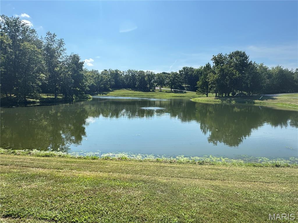 Exclusive Development come Fall in love with this beautiful 5-acre lot +- overlooking the subdivision lake and back to trees. Perfect for a walkout basement. Plans to be approved must be approx. 2700 sq ft. Beautiful sunsets over the lake while you sit on your front porch and enjoy. Convenient to the highway. Just minutes from town. Call today.