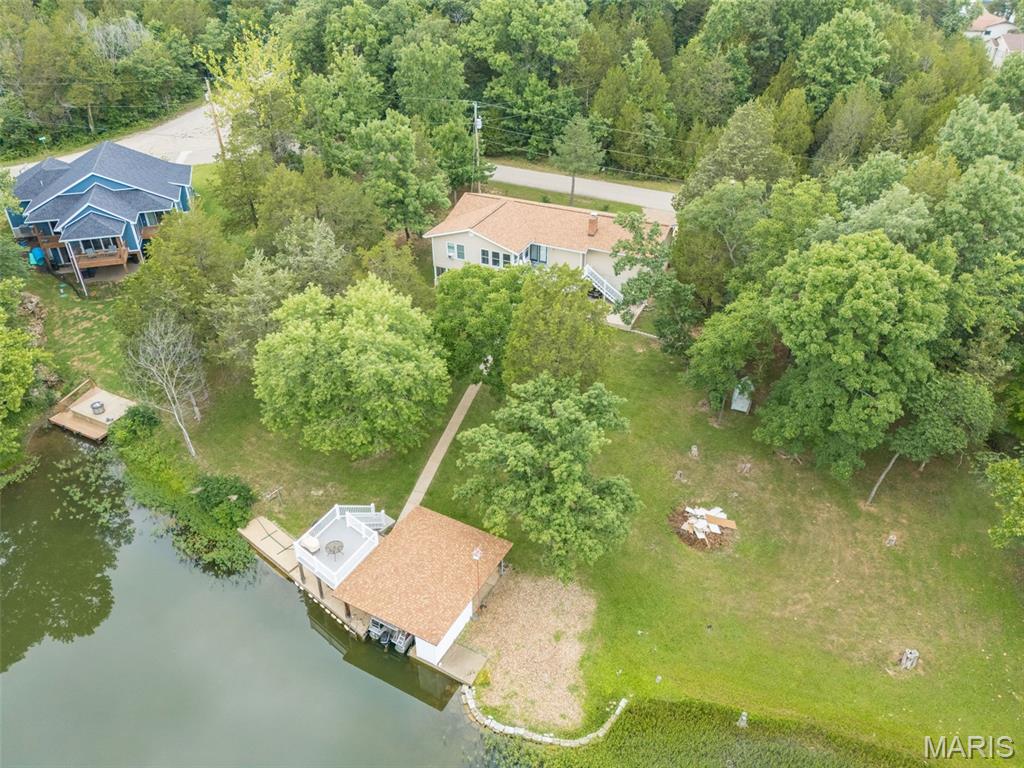 Lake living on beautiful Lac Lafitte, one of Terre Du Lac’s ski lakes. This well-cared-for 4 bedroom, 2 bath home offers an open floor plan with an updated kitchen and plenty of natural light. Enjoy lake days from your covered boat slip with upper sun deck—a perfect spot for relaxing or watching the 4th of July fireworks.  Additional features include a screened-in porch, covered patio, woodburning fireplace, and a 2-car garage. Pride of ownership shows throughout with many updates already done for you.  Mostly turnkey with most things staying with the home. Price includes the home and the lot it sits on. Adjacent lake lots on each side are available for purchase for the right price.  Schedule your appointment today and start enjoying lake life.