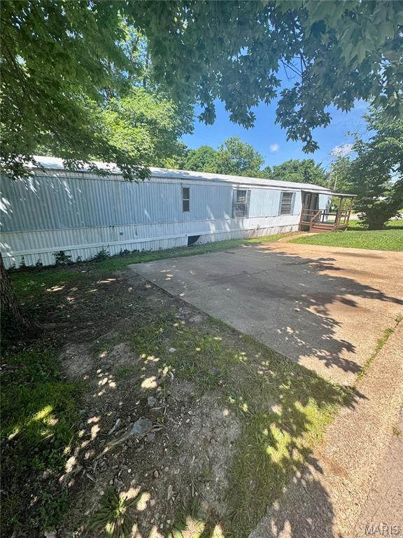 Here's your chance to own and stop renting! Located just minutes from Gravois Bluffs. Simplistic layout that feels open and airy. Plenty of cabinet space in the kitchen that also features a double bowl sink as well as a built in glass china display cabinet. The Bay windows will be the perfect setting to enjoy your meals!. Breakfast bar area for additional dining space. The smaller bedroom has plenty of closet space as well as a built in desk area. The bathroom is spacious with a garden tub/ shower combo, double vanities, and laundry located with built in storage.. The primary bedroom is spacious and also has two built ins with direct access to the bathroom. Utilize these for dressers, desk areas, or a make up vanity. The options are endless. Step into your partially fenced FLAT yard and just imagine the potential of what you could create. shed is included. Carpets were just cleaned. Property has HUD tag and the state registration/tax decal. There are various items that would need to be addressed to do a loan. Seller is selling as is.