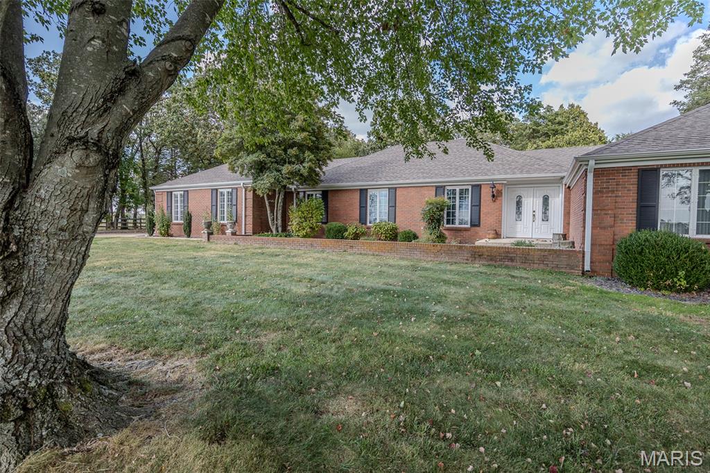 Enjoy peaceful country living just minutes from town! This beautiful ranch-style home sits on 28 secluded acres on the south side of town, featuring a paved driveway and a park-like setting full of wildlife. With over 4,000 sq. ft. of living space, this 5-bedroom, 4.5-bath home offers plenty of room for everyone. Inside you’ll find multiple living areas including a formal living room, family room with fireplace, den, formal dining room, breakfast room, and a large kitchen with tons of cabinets and storage. The spacious master suite features a relaxing master bath with a separate shower and walk-in tub. Step outside to a huge back patio—perfect for entertaining or just relaxing while you watch the wildlife. Property also includes a 30x40 barn with concrete floors, a large shed/barn for extra storage, and some fencing already in place. The perfect mix of country comfort, privacy, and convenience—just minutes from town!