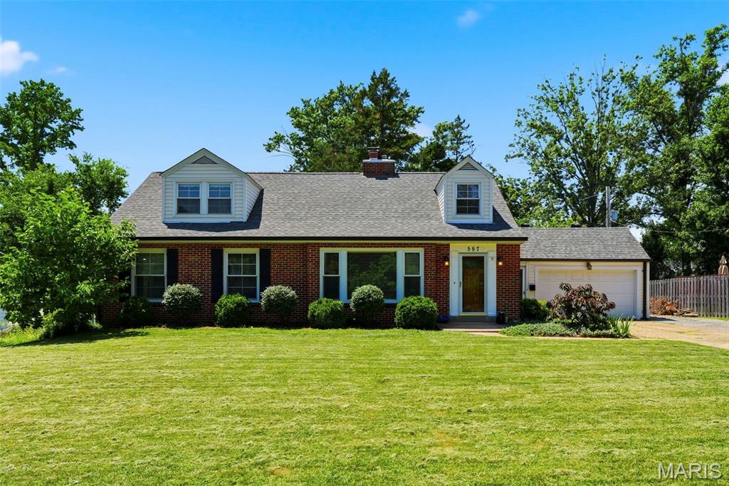 This charming 1.5 story home nestled in the heart of Kirkwood offers 4 spacious bedrooms; 2 on the main level and 2 on the upper level and has 2.5 updated bathrooms. Entering through the front door into the main living room, you will be greeted by the warmth of the gleaming hardwood floors, wood burning fireplace and mantle (fireplace liner was replace in 2021) and large panoramic lookout window. Both the dining and living room has beautiful natural light streaming through the windows to allow for a warm glow throughout the front of the home. The kitchen has ample room to create your own workspace area or perhaps design an eat-in kitchen. The sunroom/screened in porch is off the kitchen and is perfect for entertaining and just watching TV or reading a good book. The upstairs boasts of an updated wrought iron stairway, and the two upper bedrooms are quite generous on space as well. Each of the two upper bedrooms have built-in bookshelves and adds to the charm of the home. There is a large cedar-lined walk-in closet off the hallway for extra storage. Many storage closets throughout the home as well. Except for the kitchen and screened-in porch, all rooms on the main and upper levels have real hardwood floors that have been completely refinished. The lower level has a carpeted recreation room and a ½ bathroom as well. The backyard is level and has a tree-lined fence to allow for privacy. There is an attached 2-car garage that you will love! Close to stores, restaurants, award-winning Kirkwood schools and transportation, you will quickly fall in love with this home.