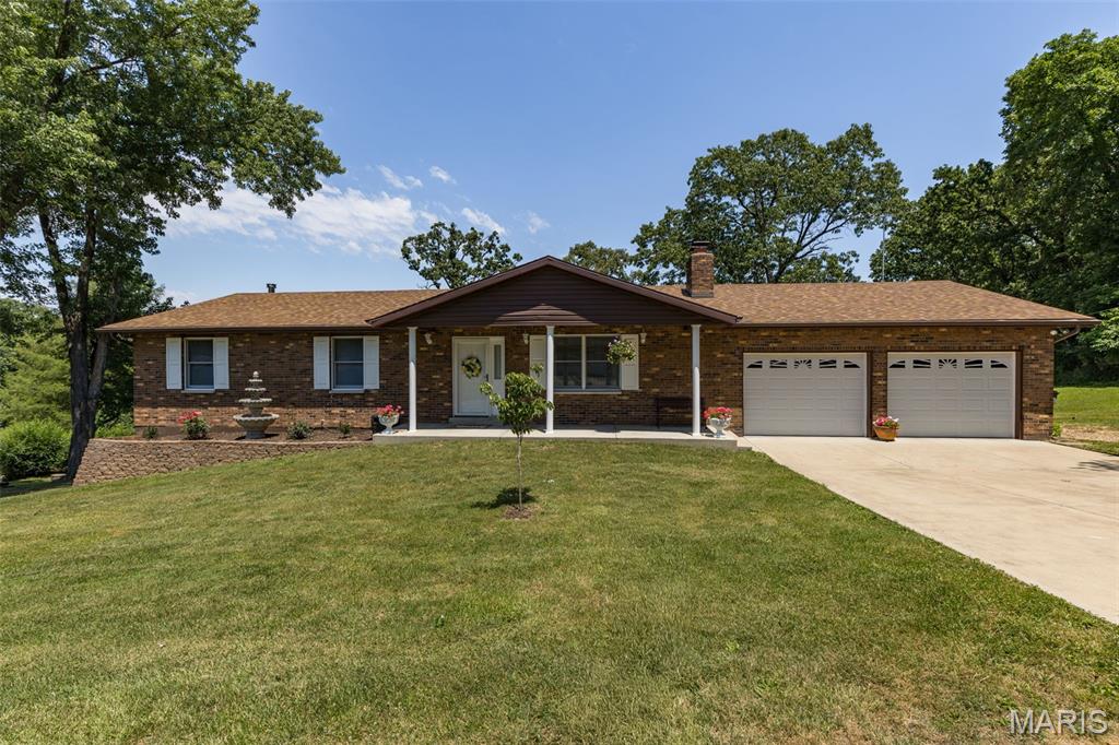 Meticulously maintained  all brick 3 bedroom and 3 full bathroom home in the highly sought after R-7 school district. Hurry to see this one! Enter the home to a large living room with beautiful gas fireplace. Large kitchen with lots of cabinets and counter top space- nice large pantry and room for eat-in breakfast table- separate large dining room- center hall plan has large full bathroom, large bedrooms 2 and 3 and a very nice primary bedroom with full bathroom. Off the dining room you walk out to the gorgeous large deck overlooking that big back yard! So much space to entertain or relax and enjoy the end of street privacy! The oversized 2 car attached garage has ample space for those long trucks and still have a nice workbench area too- back inside head down to the finished lower level with beautiful living room/rec room- another full bathroom- laundry and storage room too! A very nice walk out to the back yard that has also been nicely maintained- this home is perfect-come see for yourself!