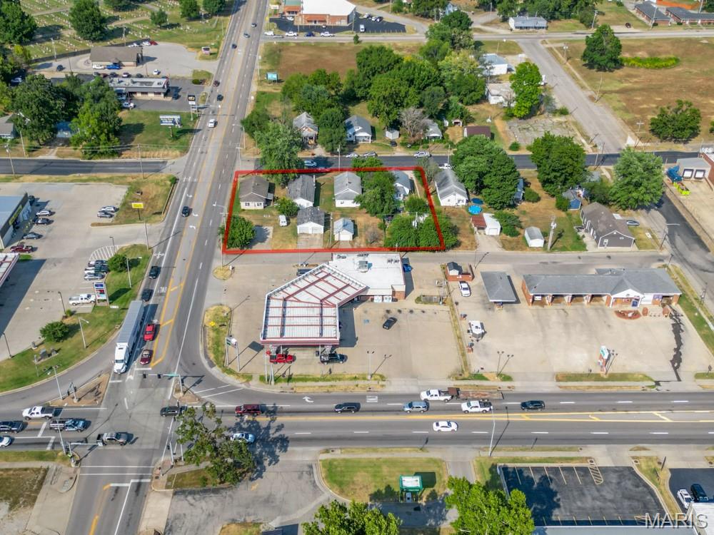 Exceptional commercial opportunity to own four houses situated together on a prime lot along a busy highway with an impressive traffic count of approximately 7,500 cars per day. Whether you're an investor looking to generate rental income from the existing homes or a developer seeking a high-visibility location for a new business venture, this property offers incredible flexibility and potential. The combined lot provides ample space for redevelopment, making it ideal for retail, office space, or other commercial enterprises. With strong visibility and easy access, this is a rare chance to secure a valuable footprint in a high-traffic area with unlimited potential.