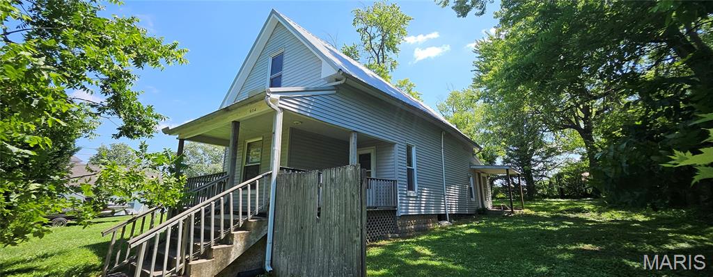 This 2 bedroom 1 bath has lots of extra space for a house this size, including a small bonus room that could function as a 3rd bedroom or office. Pull in from the rear alley to a 2 car detached carport near the rear of this elevated lot and enjoy the privacy of a sparsely populated area in a small town. It needs some work but for this price range it has great potential!