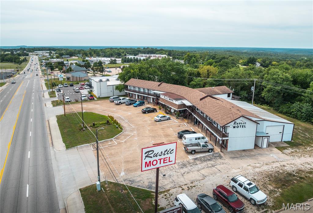 The Rustic Motel sits in a high-traffic commercial area with excellent visibility and close access to major routes, making it convenient for travelers. Surrounded by restaurants, Walmart, Staples, and other established businesses, the location is ideal for steady guest flow and future growth.

This two-story motel offers 25 guest rooms, each furnished with essentials such as TVs, air conditioning, private baths, sitting areas, dressers, refrigerators, and microwaves — everything guests need for a comfortable stay. The property also includes a residential living space for on-site management and extensive storage with overhead doors, adding practical value.

Set on 1.05 acres, the Rustic Motel blends functionality with opportunity, whether for continued hospitality use or redevelopment in a thriving commercial corridor.